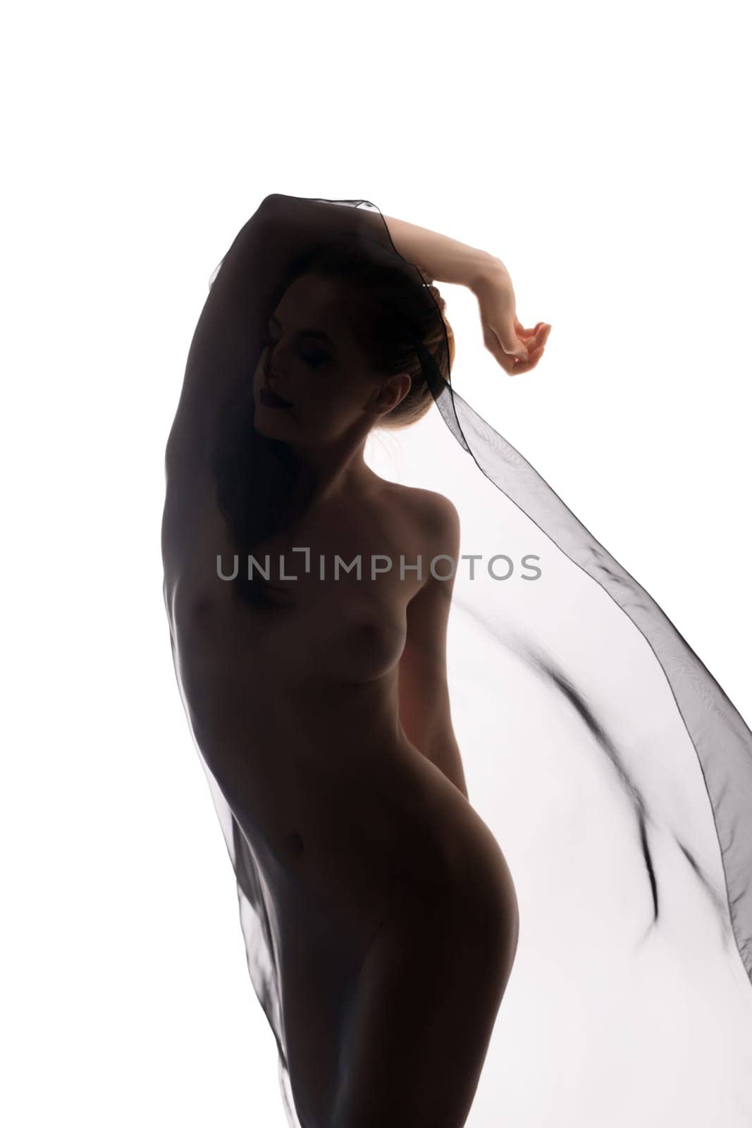 Graceful naked woman dancing with transparent cloth. Isolated on white background