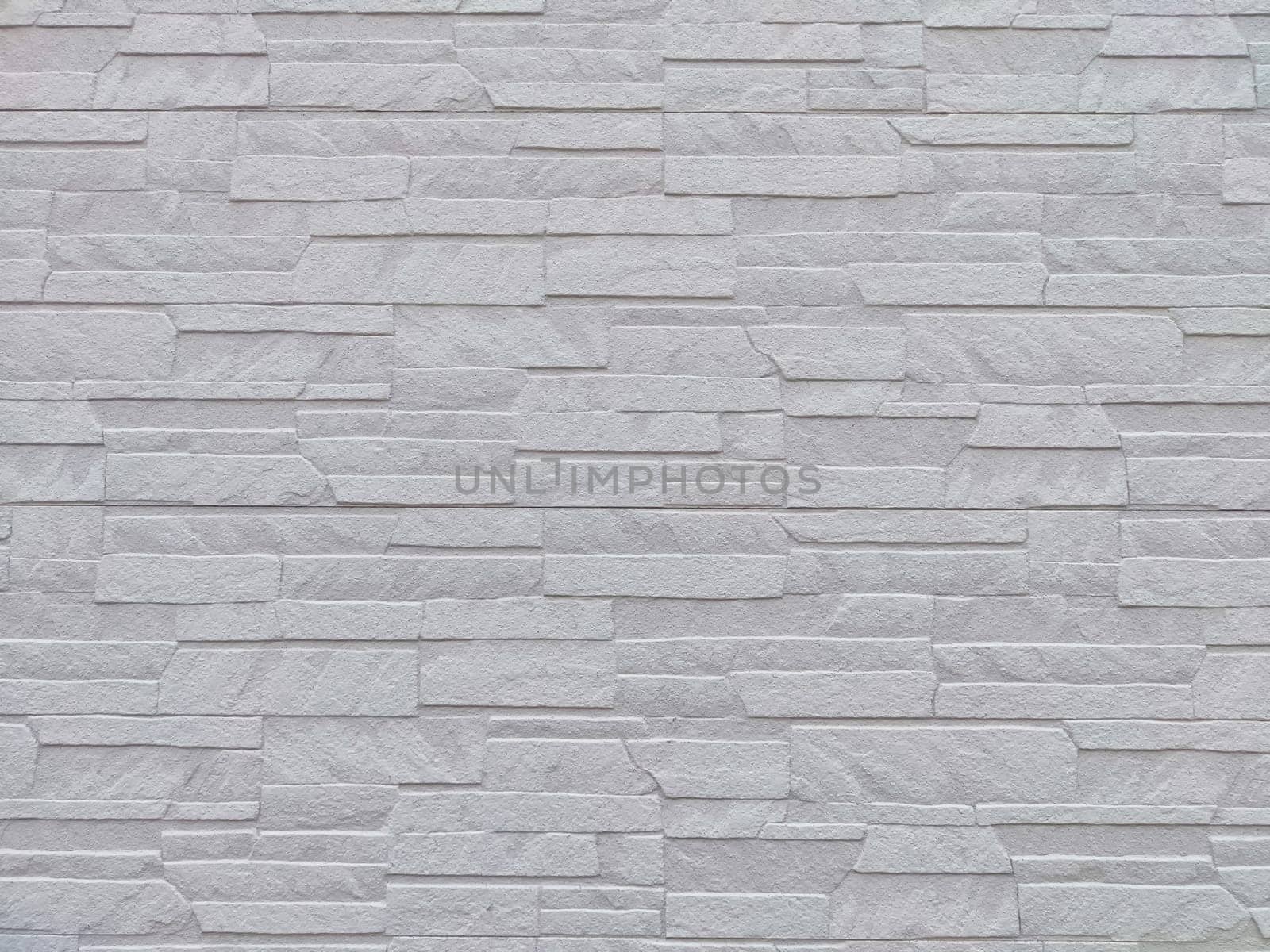 Uneven stones or bricks as background and texture. Background, texture, pattern, frame, copy space. Close-up view of a wall with uneven stone bricks