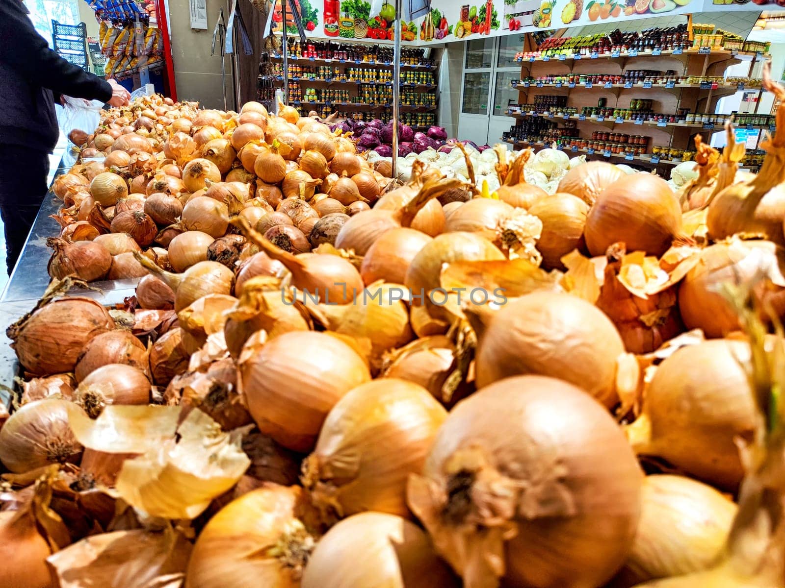 Fresh onions spread out for customers at a market. Pile of Fresh Onions for Sale at Local Market Stall