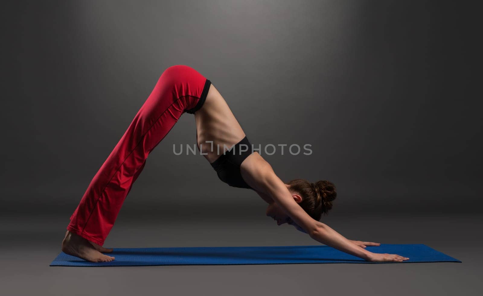 Image of lovely caucasian woman practising yoga in studio