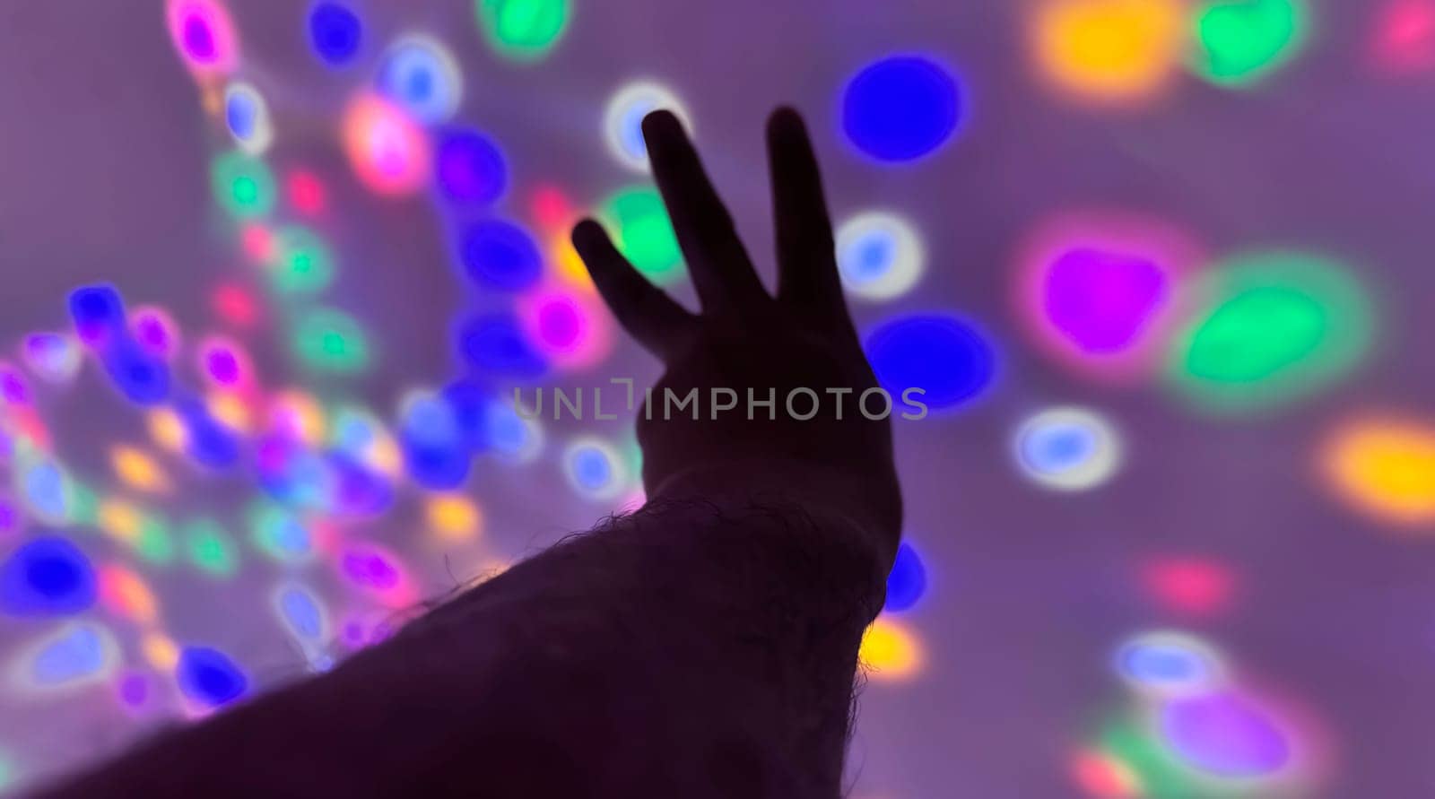 Hand gesture silhouette on a colorful background reaching out, saying hello, and show number represent for multimedia content creation