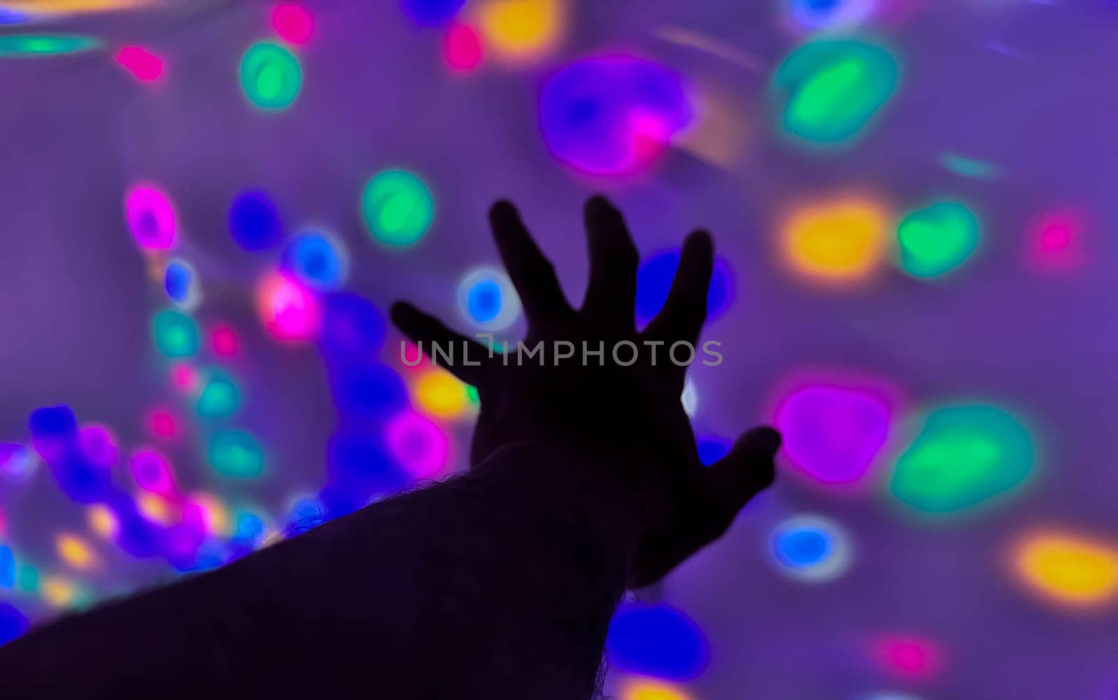 Hand gesture silhouette on a colorful background reaching out, saying hello, and show number represent for multimedia content creation