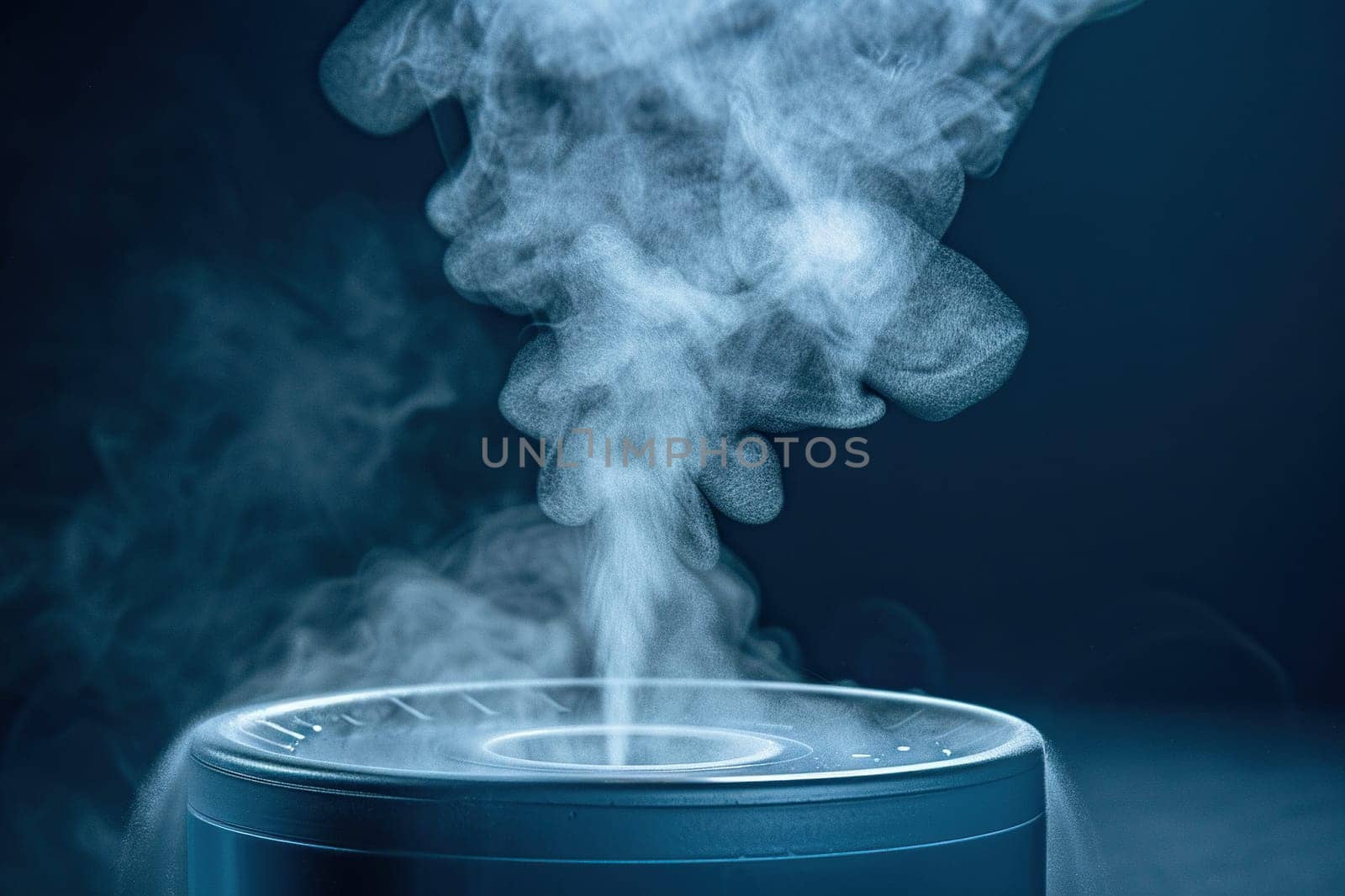 Close-up of a powerful jet of steam on a blue background. Steam comes out of the humidifier.