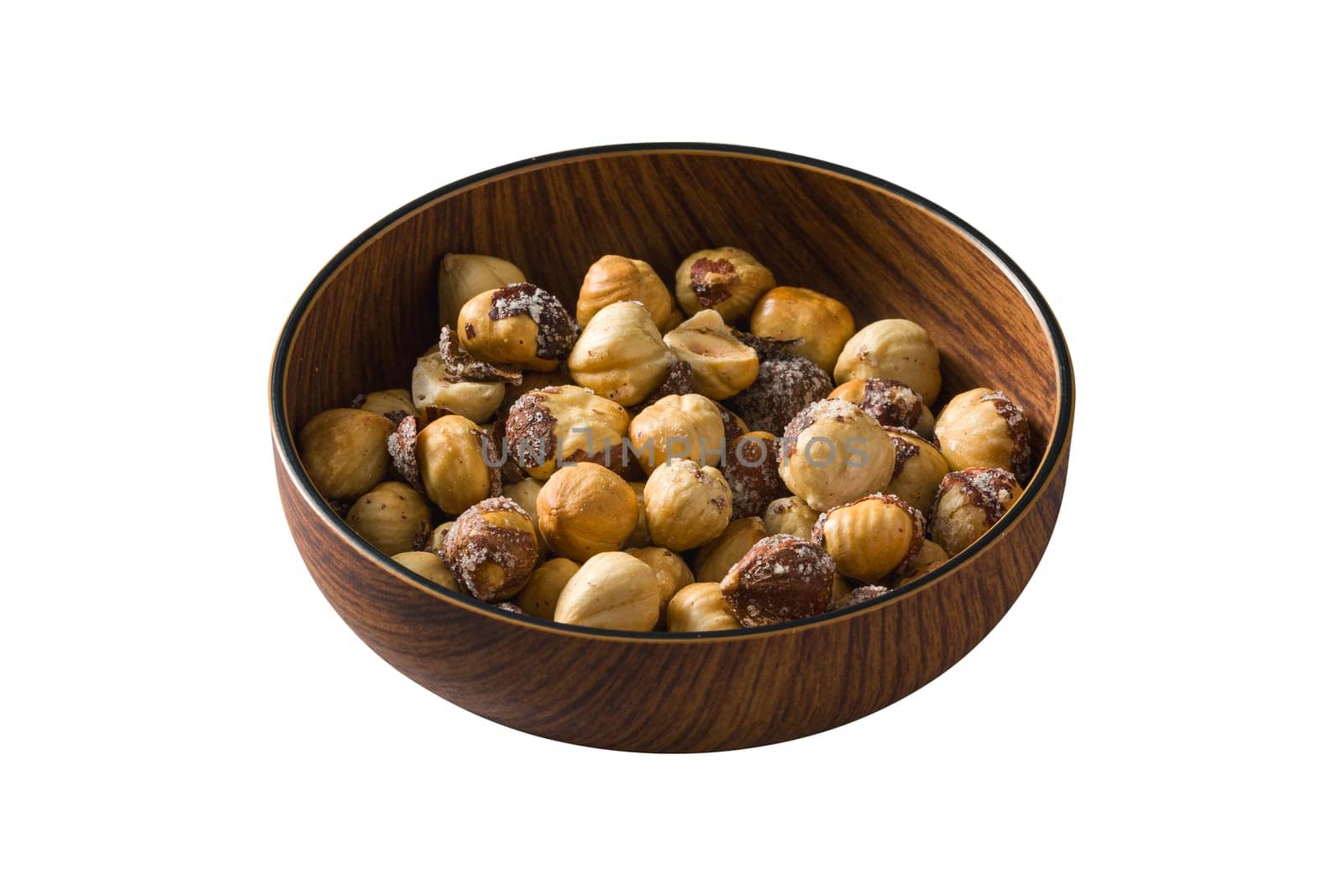 Roasted salted hazelnuts in wooden bowl on isolated white background