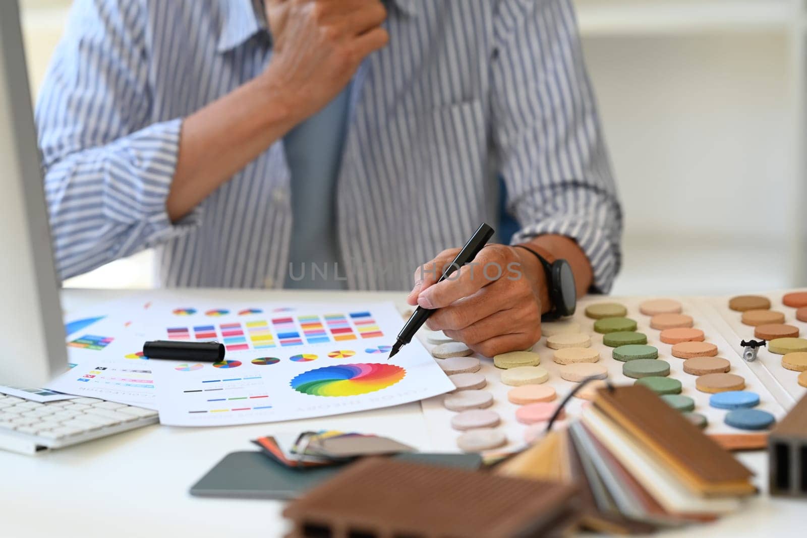 Cropped shot of interior designer working with palette choosing colors for house renovation.