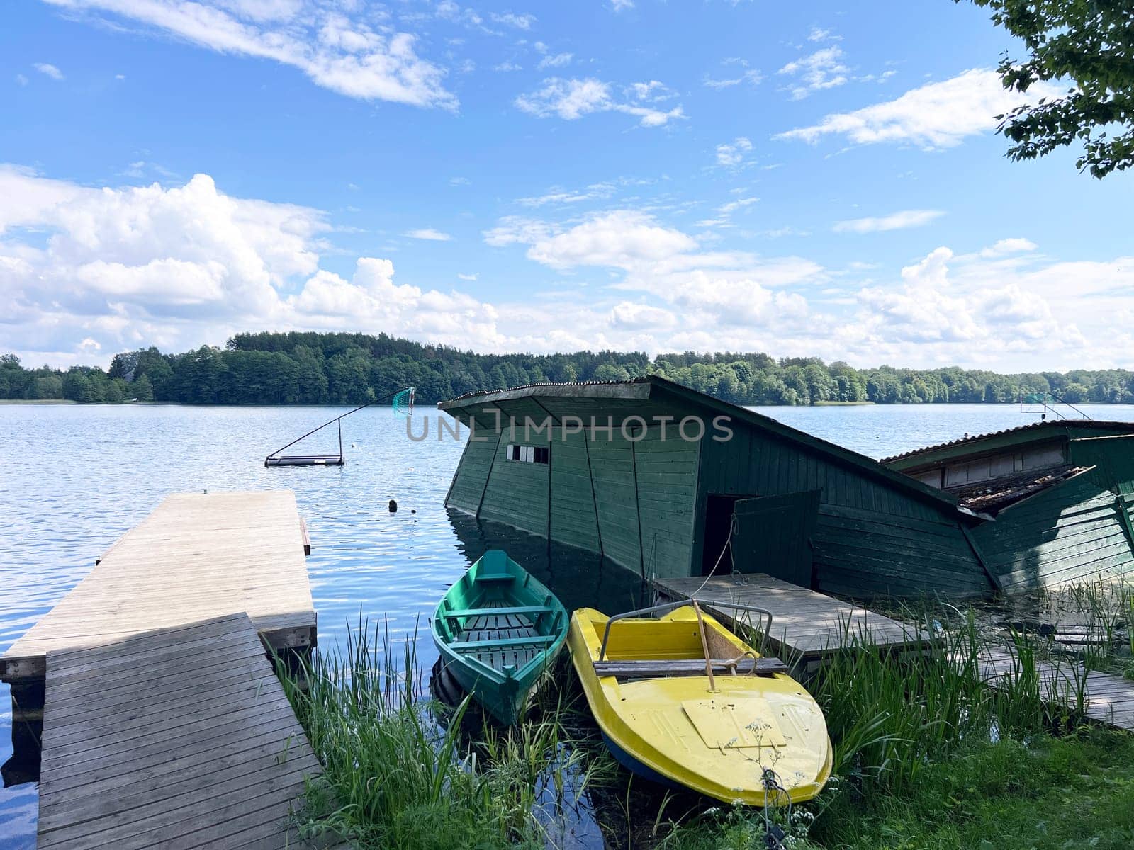Ruined house in the lake after storm some boats near in Trakai, Lithuania. High quality photo