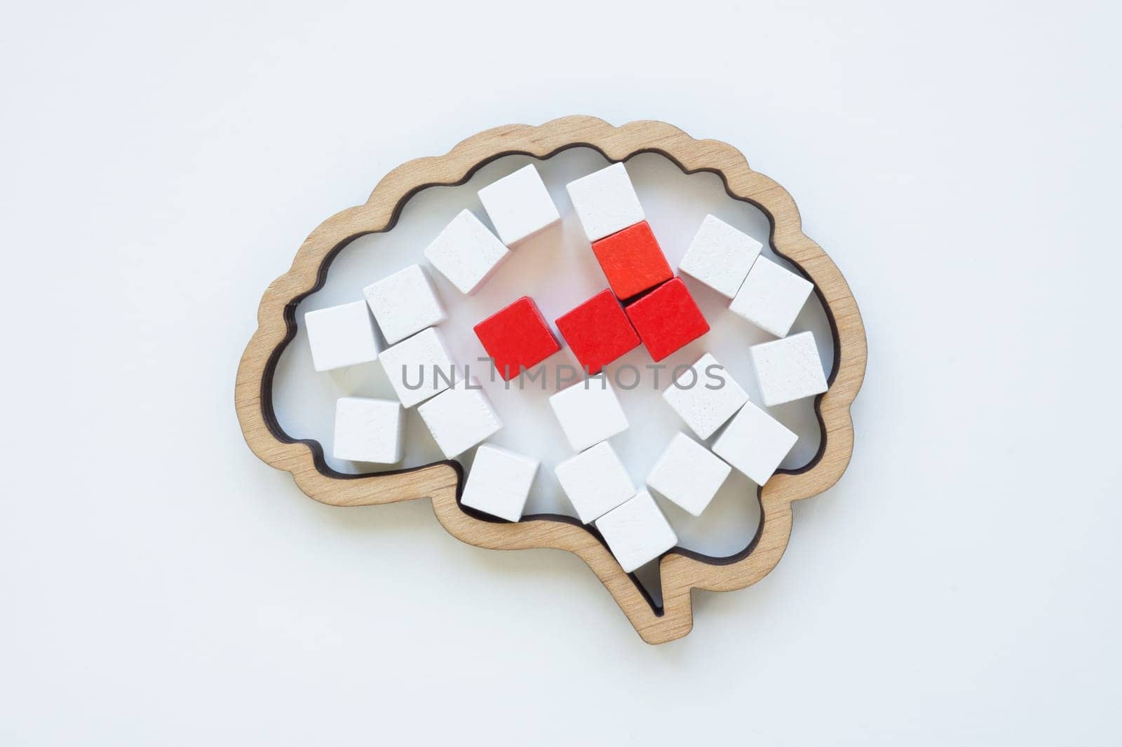 Brain model and red cubes as concept of disease or pain in the head.