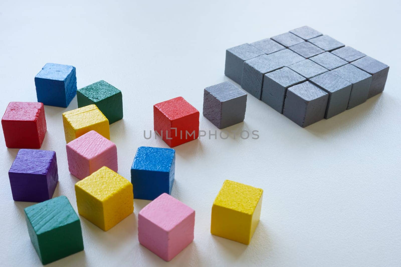 Diversity or order concept. Colored cubes and ordered structure of gray ones.