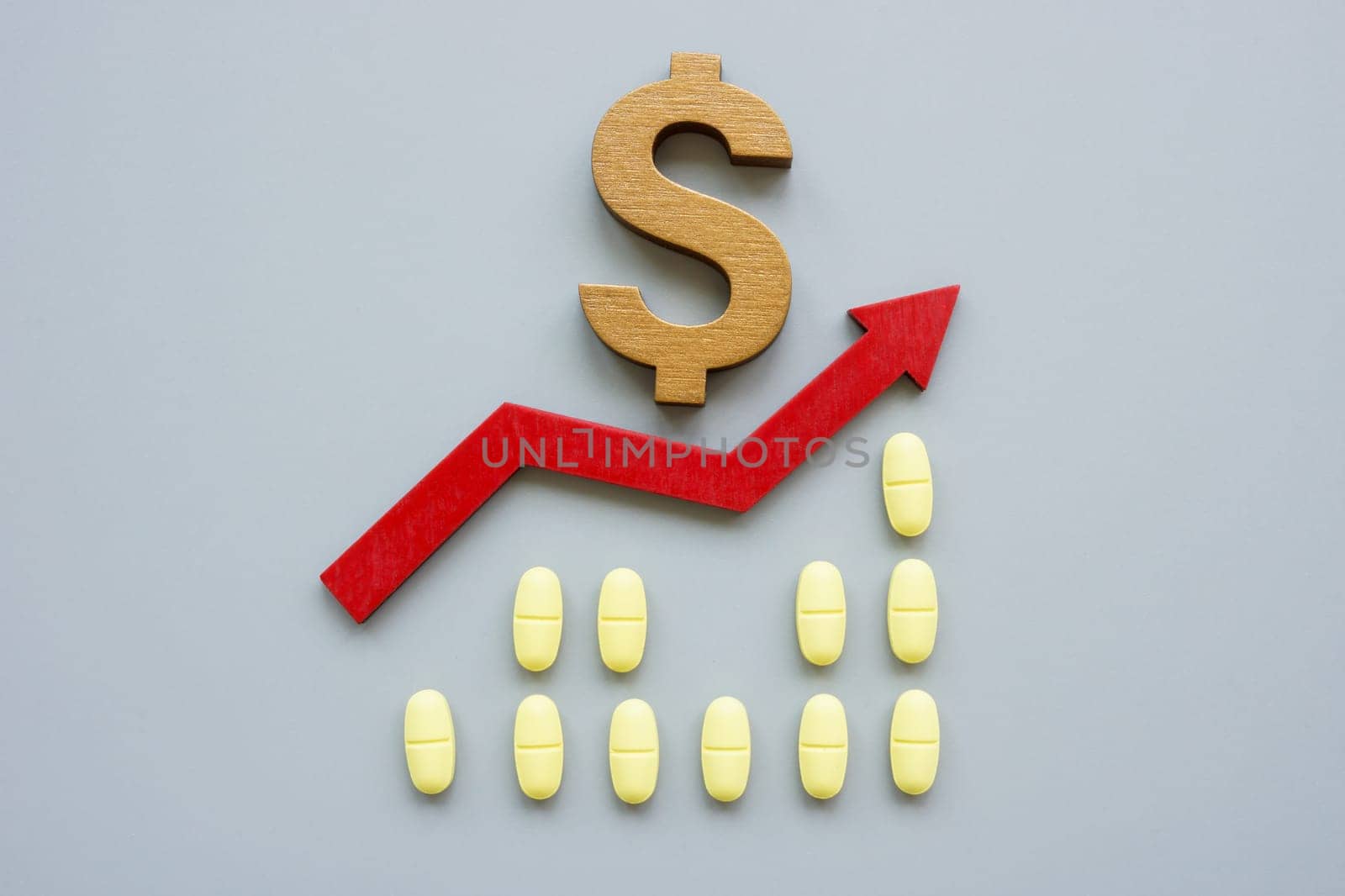 Medical pills, arrow and dollar sign. Healthcare stocks concept.