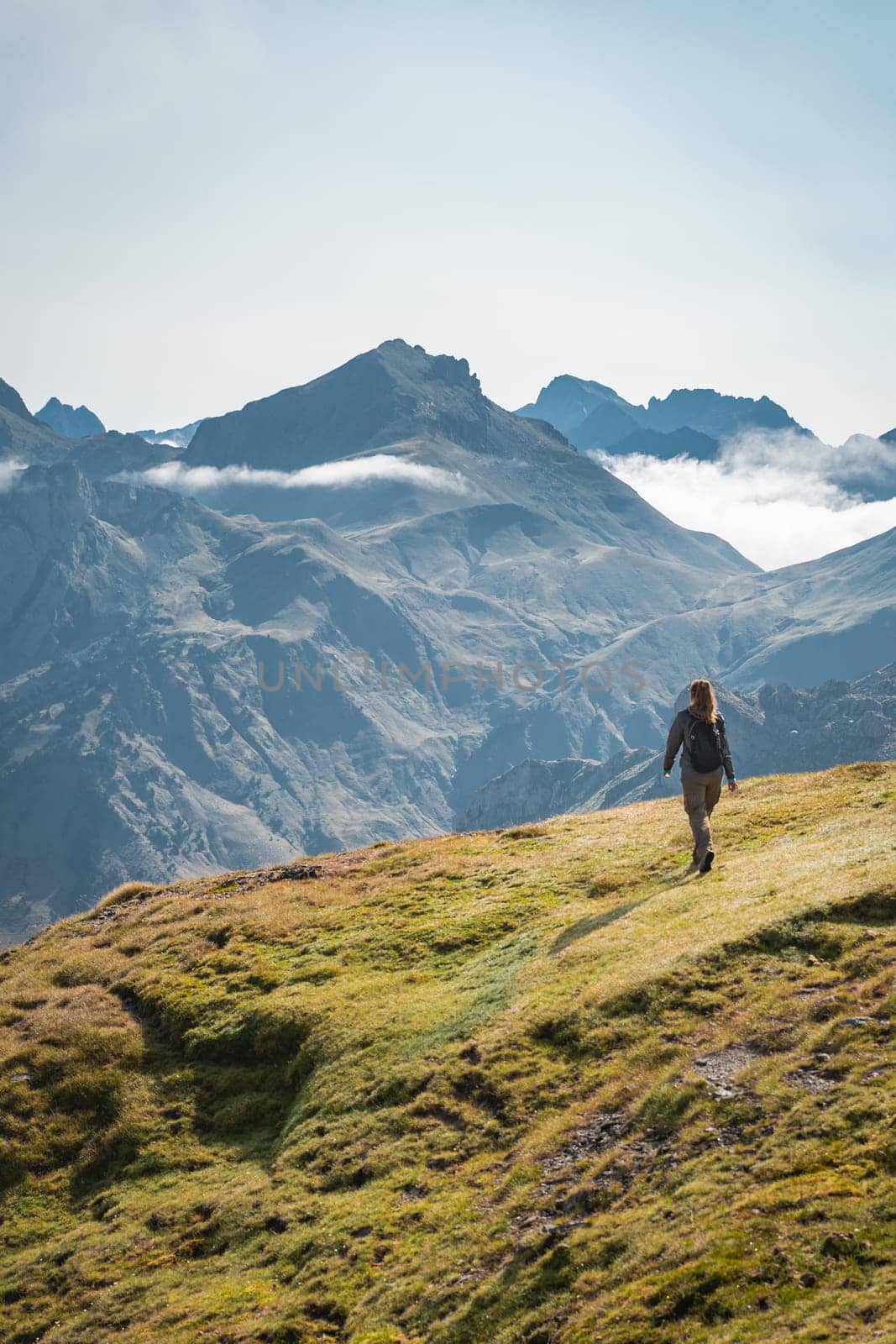 Young Woman With A Backpack on The Top Of a Beautiful wild Landscape. High quality photo