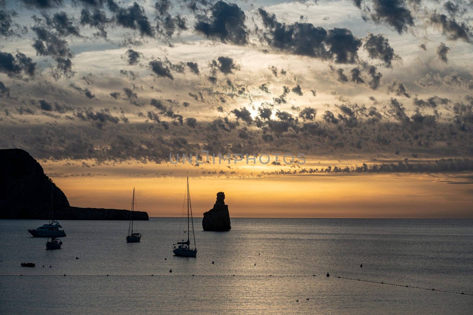 Sunset on Benirras beach in Ibiza in summer.