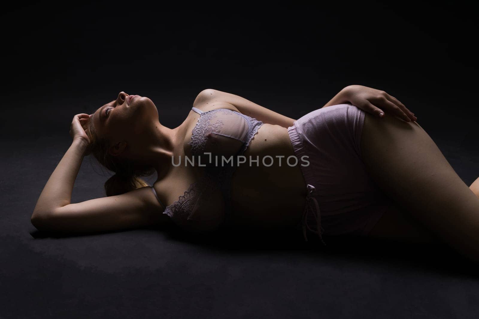 Happy plump body positive blond haired lady poses topless