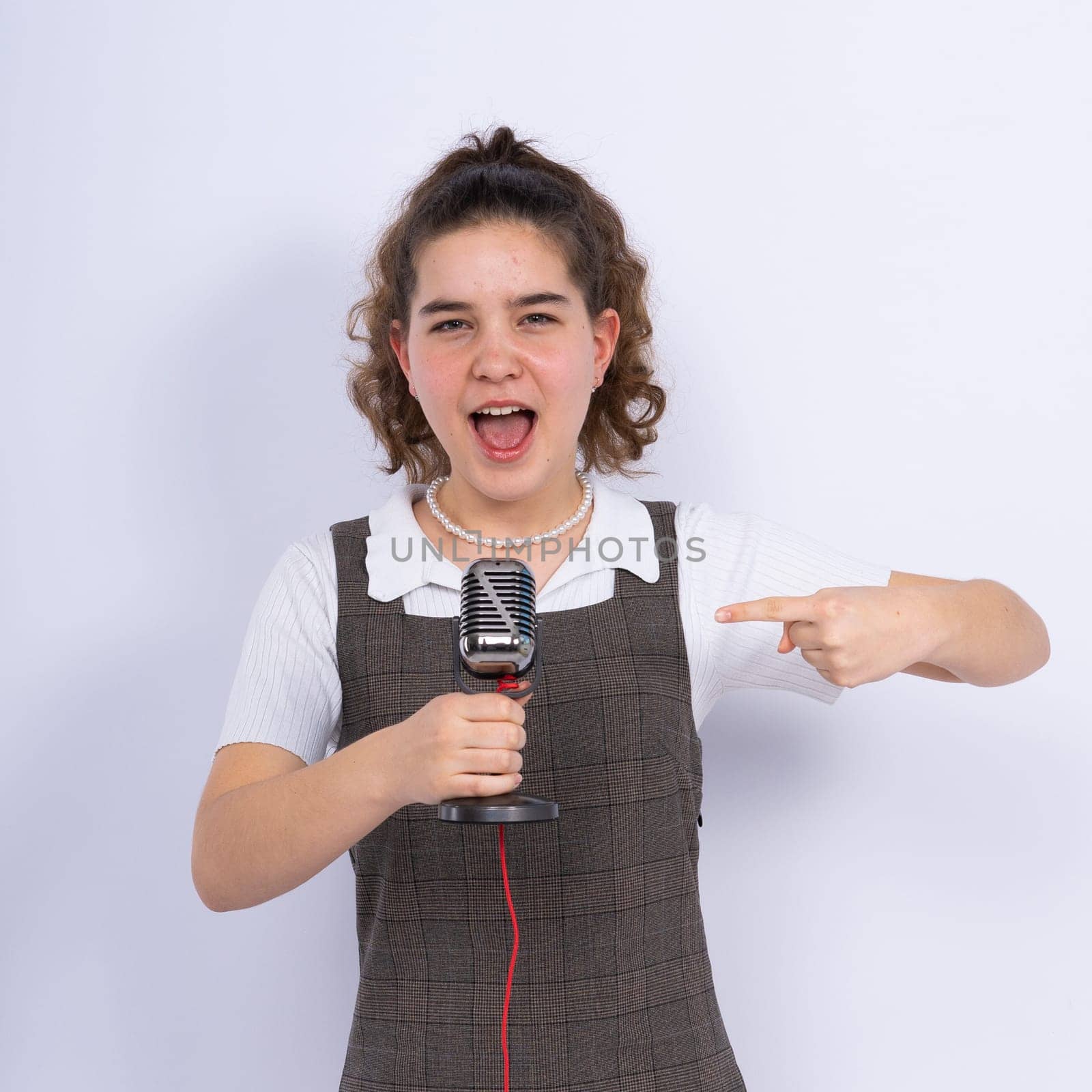 Young girl singer perform karaoke isolated on a white background