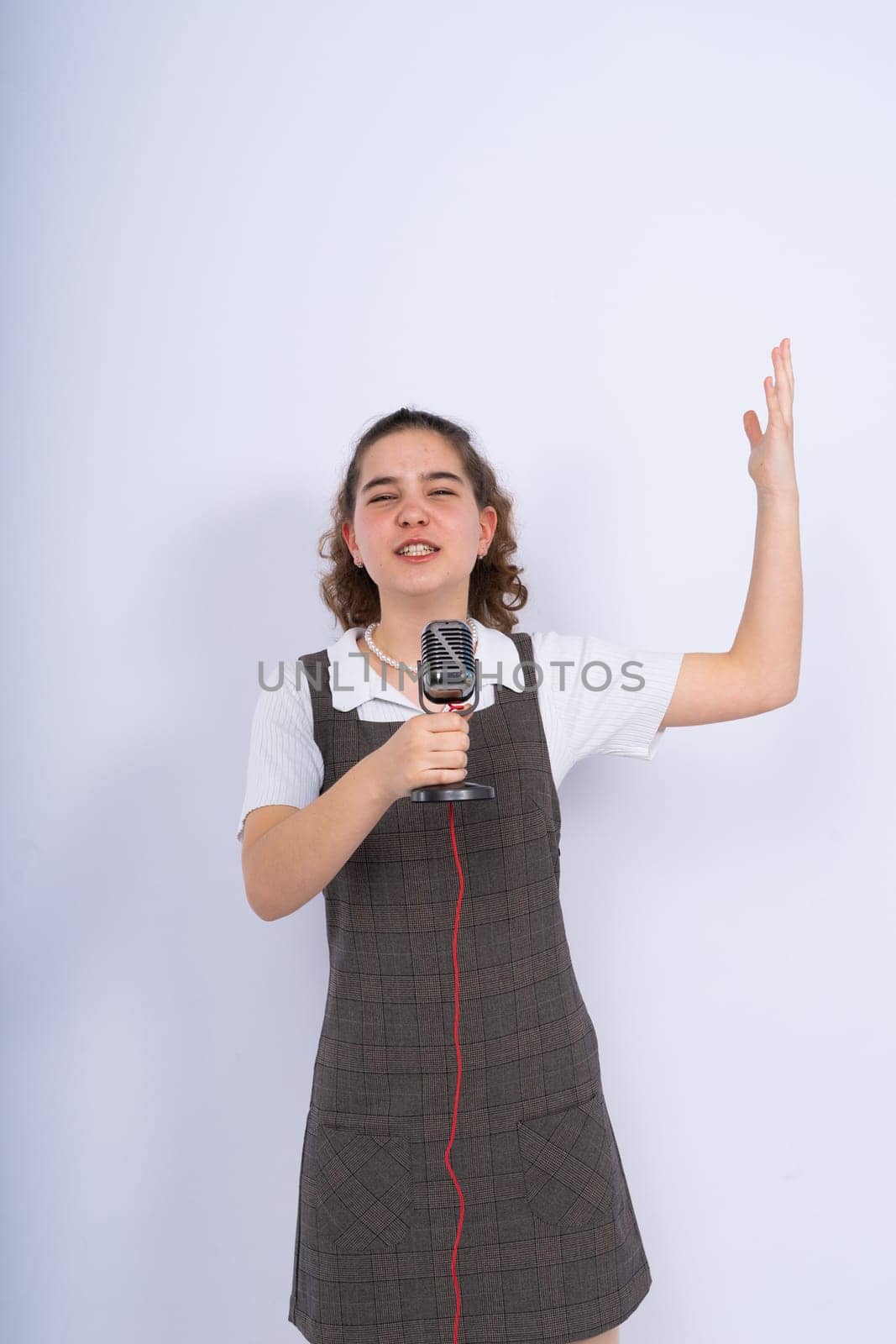Young girl singer perform karaoke isolated on a white background