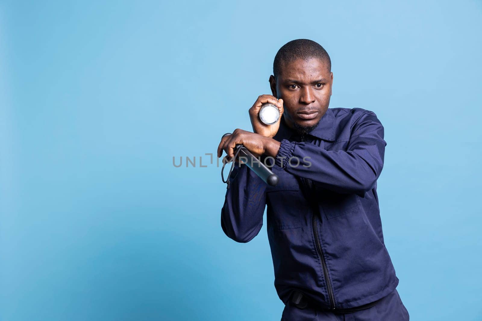 Mall security agent doing a control sweep with a flashlight in the dark by DCStudio