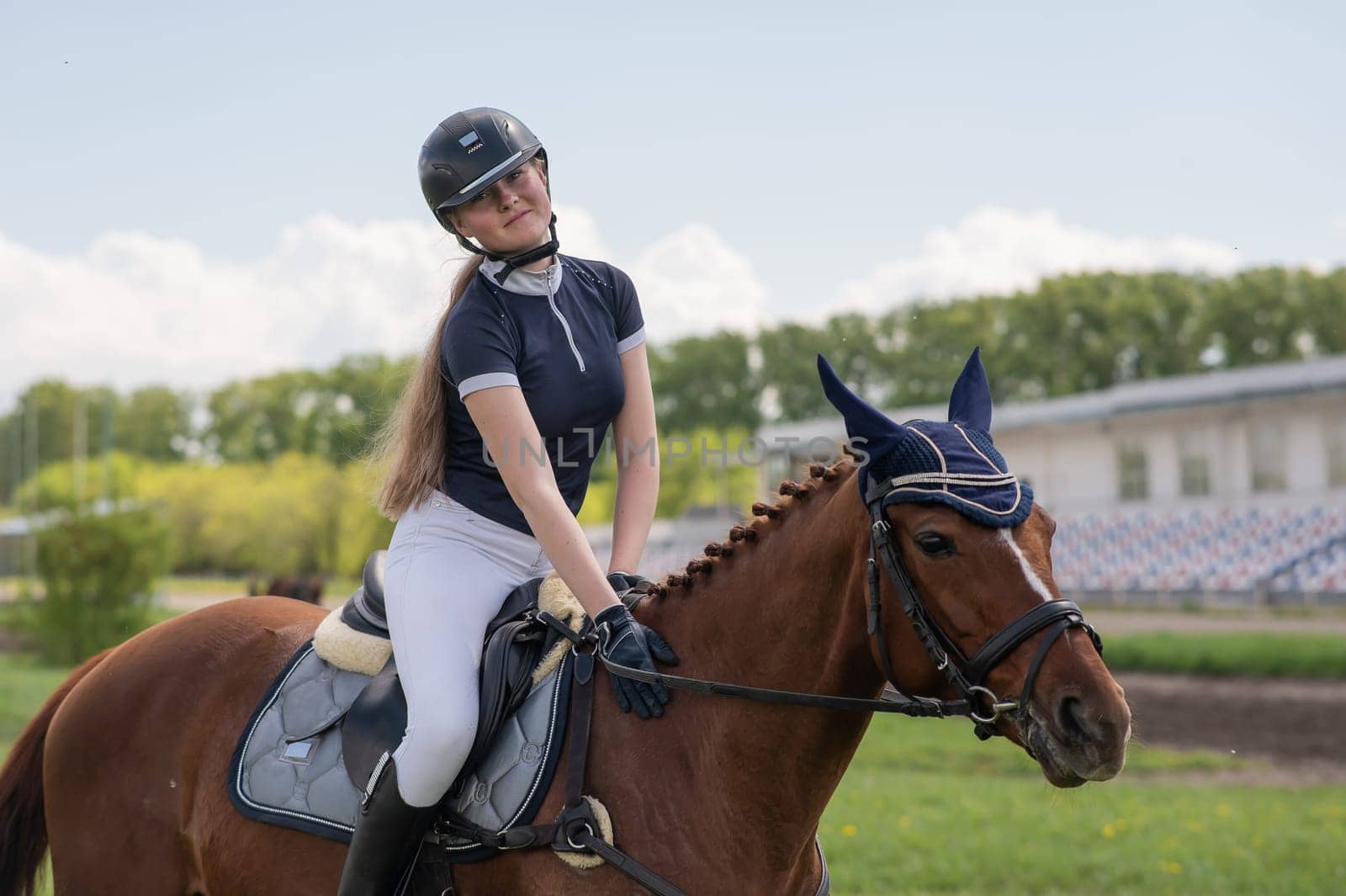 Portrait of a girl jockey riding a horse