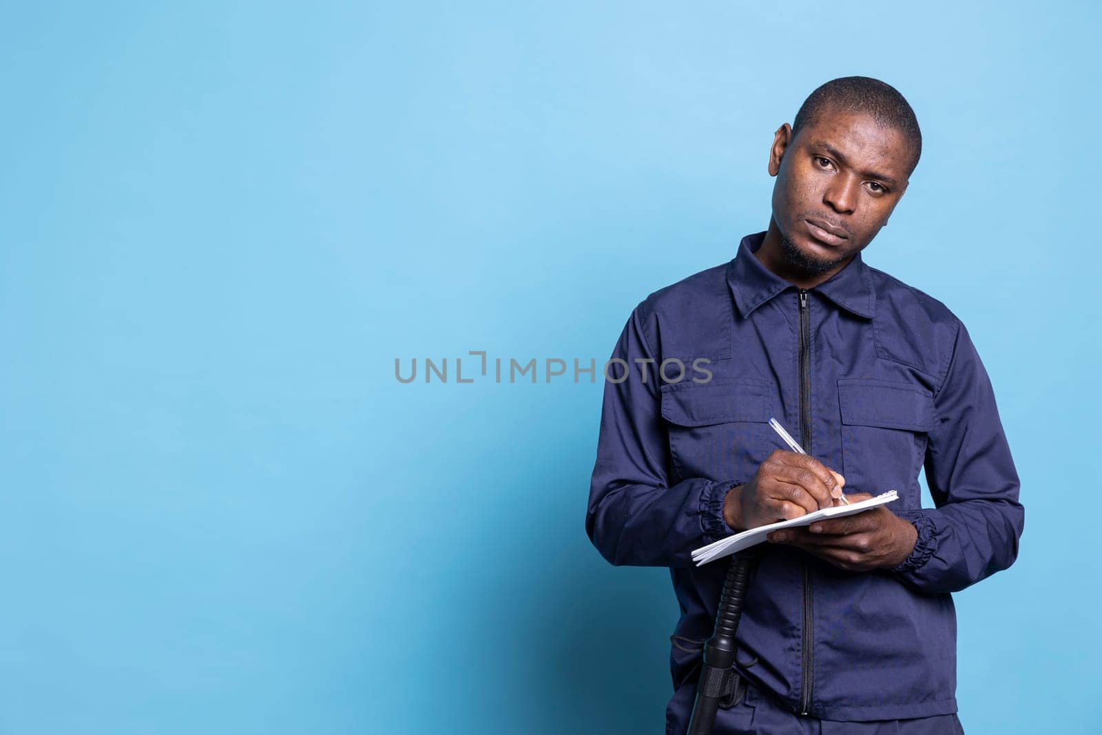 African american bodyguard writing detailed information on his notebook by DCStudio