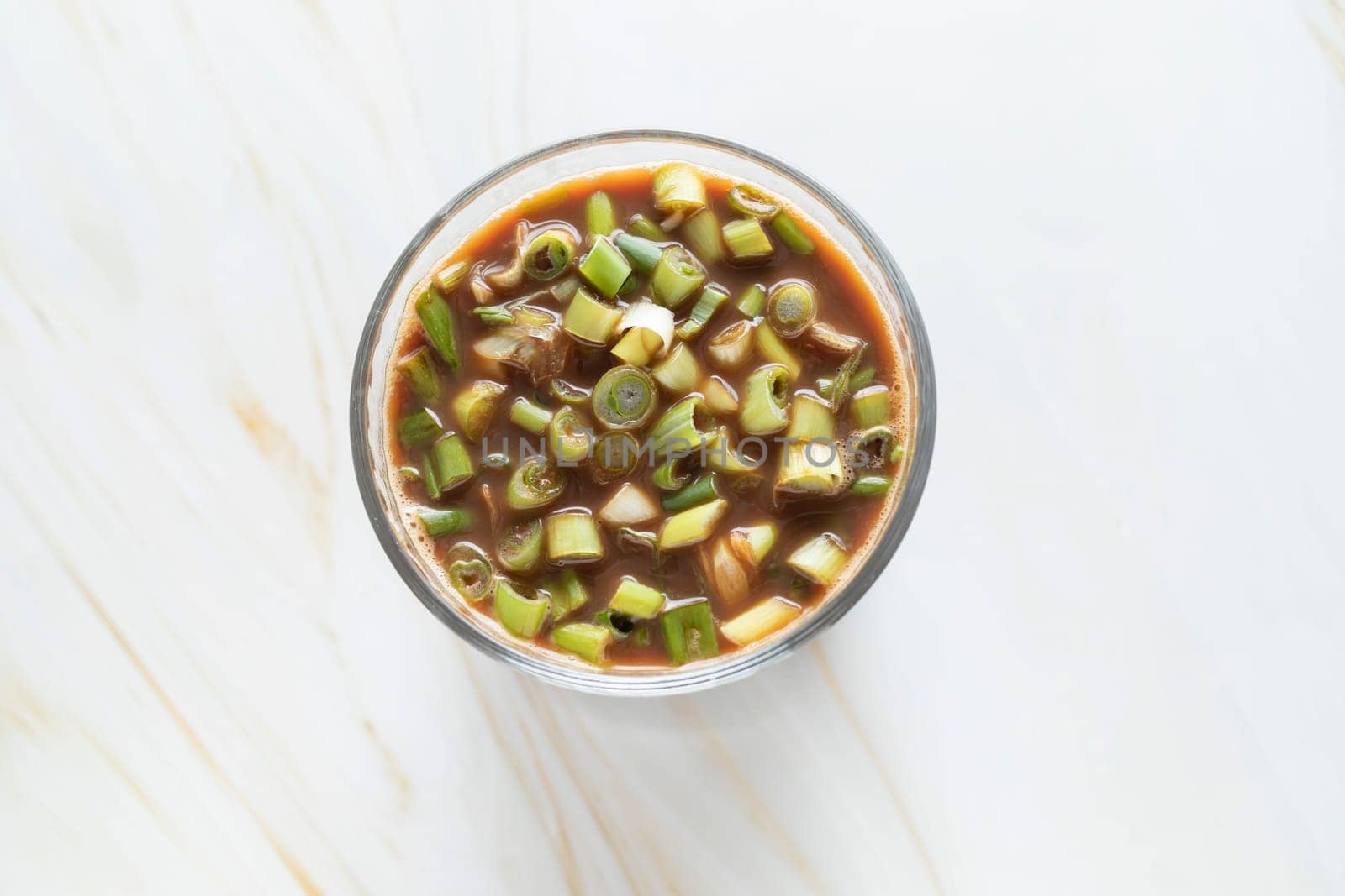 Spring Onion Coffee Or Scallion Coffee, Popular Beverage In China. Top View Glass Of Drink, Cappuccino Or Latte With Onions On Granite Table. Horizontal Plane High quality photo
