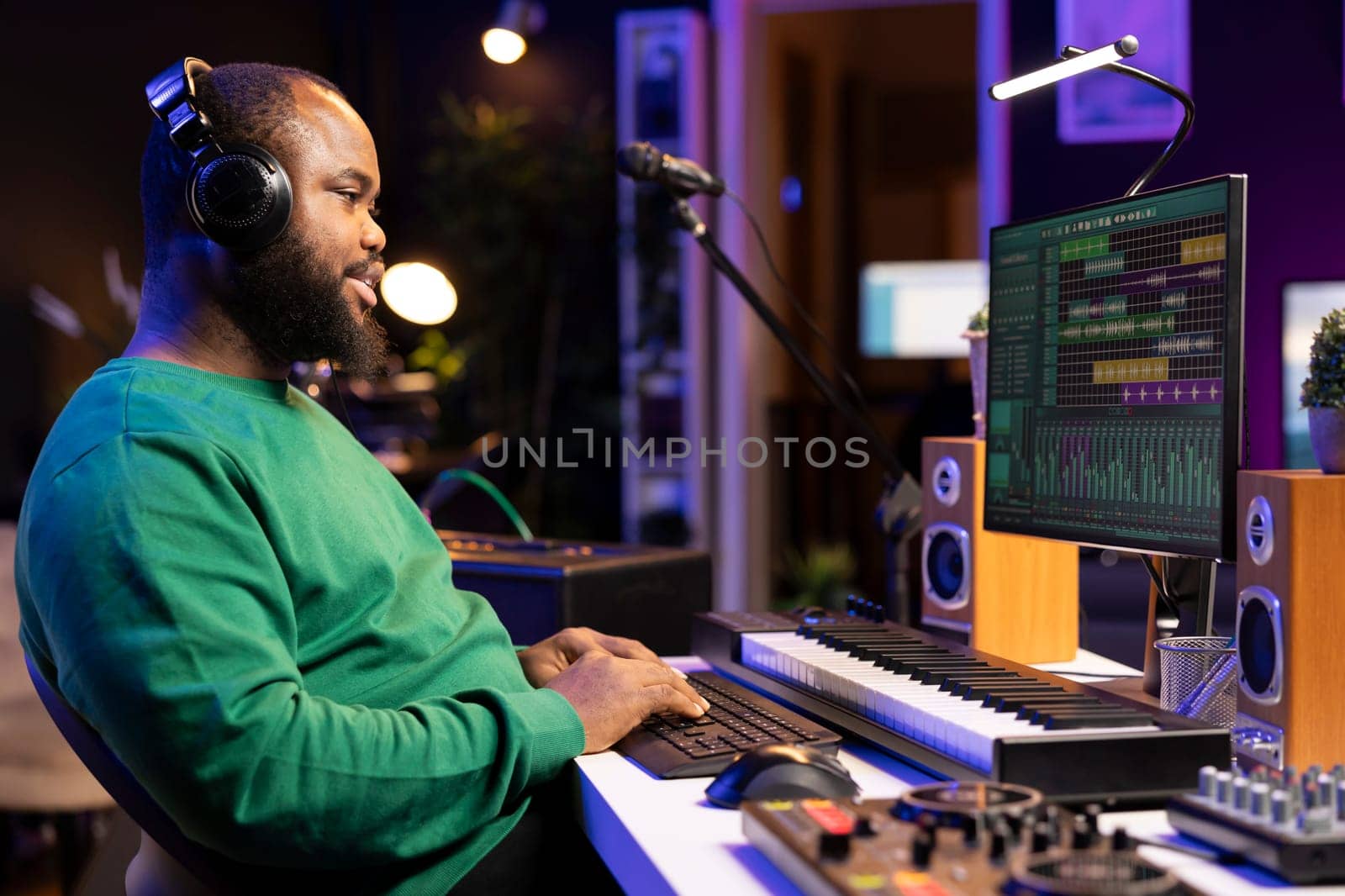 African american composer mixing and adding sounds on his recordings by DCStudio