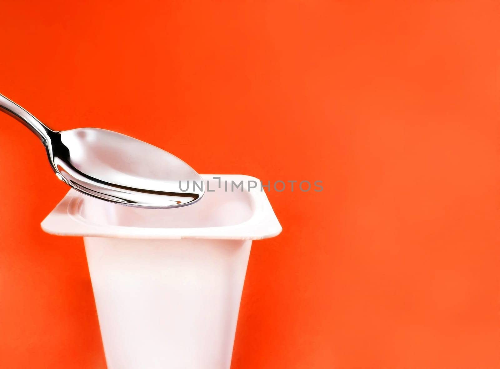 dairy and rustic farm food styled concept - natural yogurt on orange background, elegant visuals