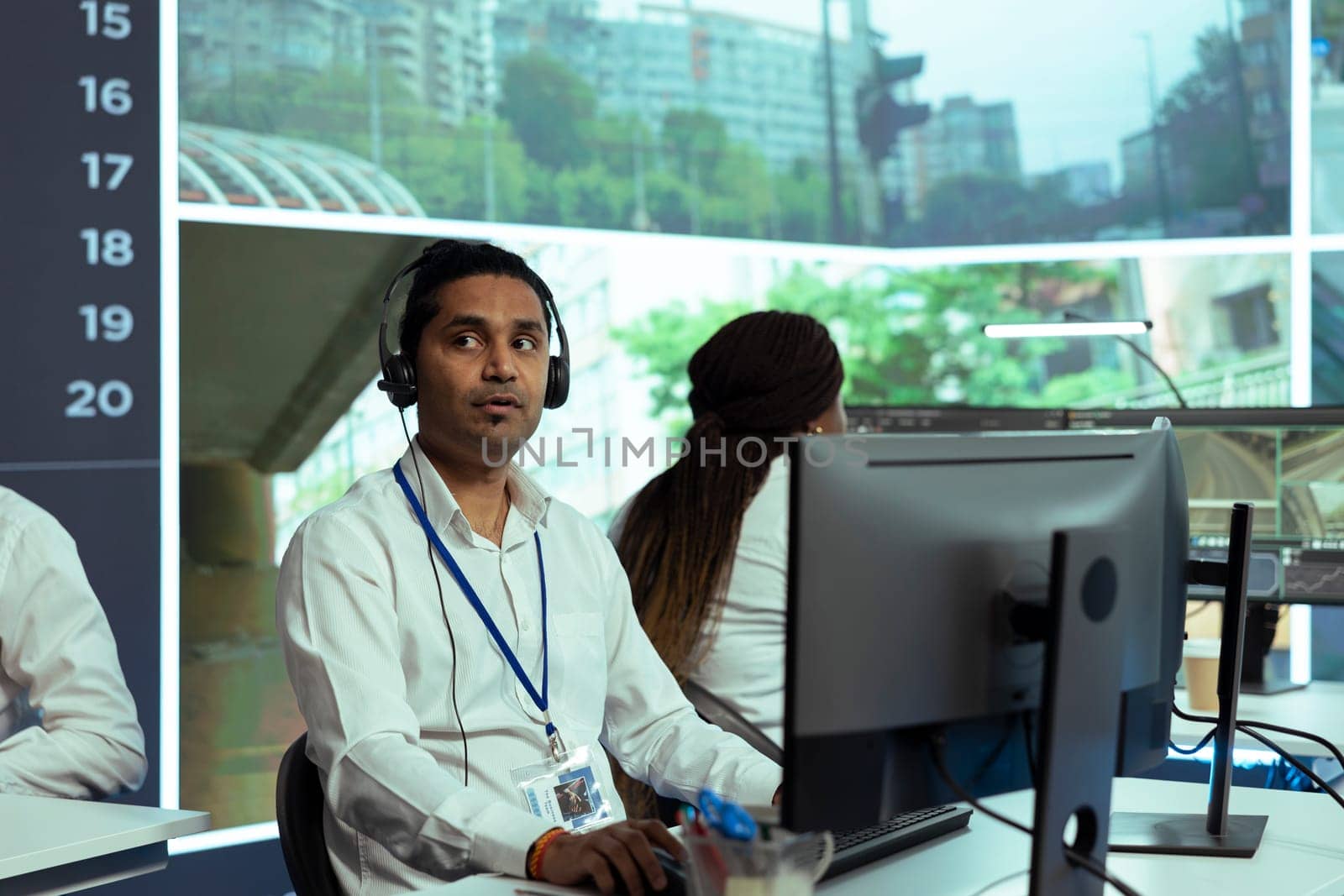 Indian employee following real time traffic activity on CCTV system cameras by DCStudio