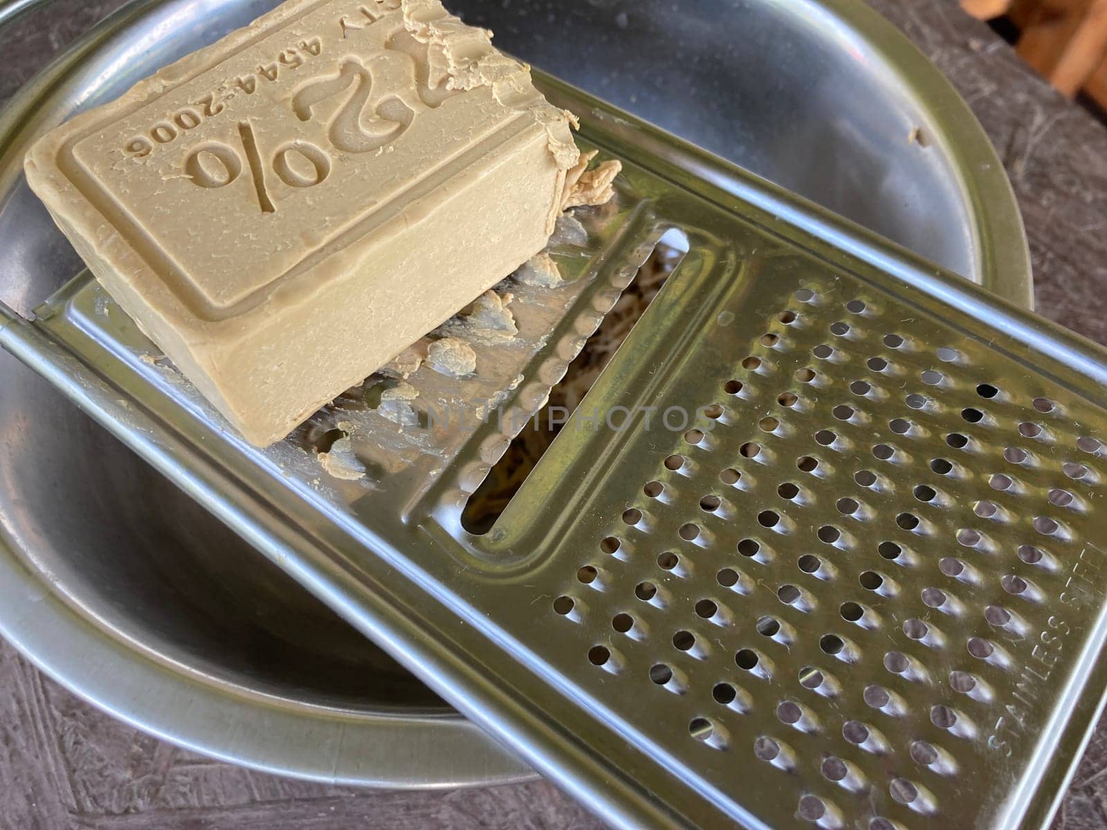 Grating laundry soap on a the food grater