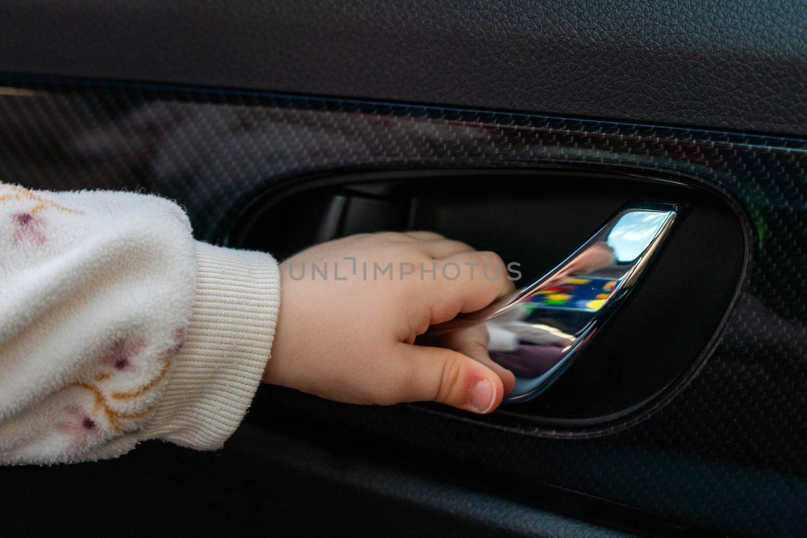 Baby arm trying to open the car door.