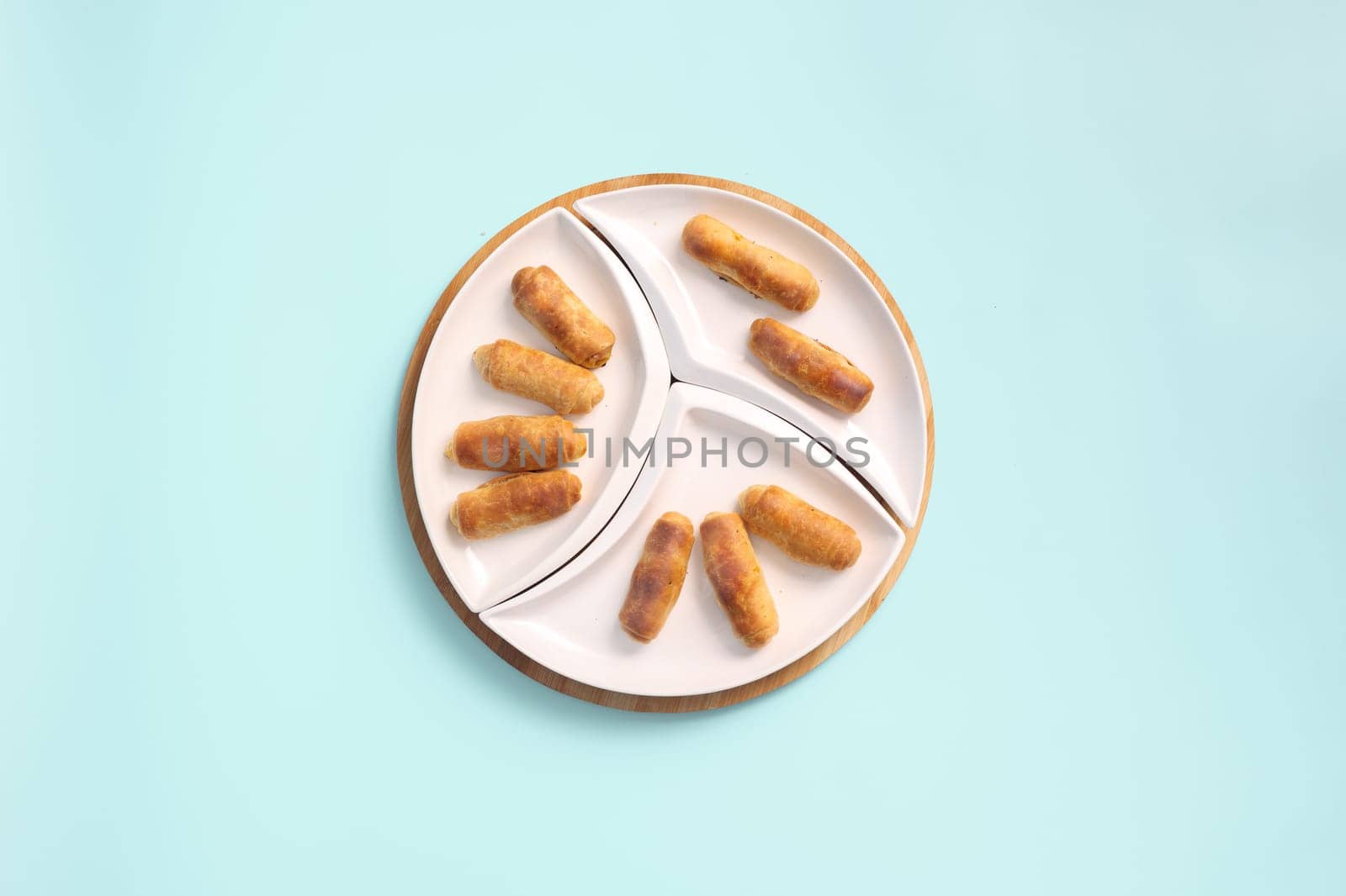 Top View of Sweet Pastries for Tea Time on a White Plate: Croissants, Sweet Rolls Or Twisted Cookies.