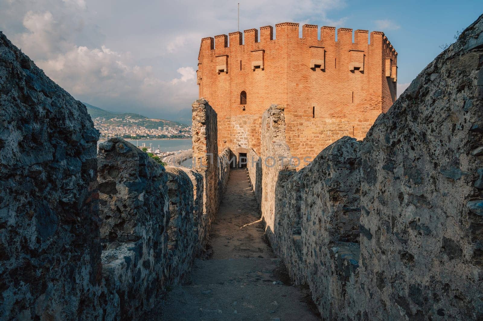 Fortress ruins of the historical Red Tower - Kizil Kule, in Alanya Castle. The Red Tower is the symbol of the Alanya city, and the famous touristic place, Turkey (Turkiye).