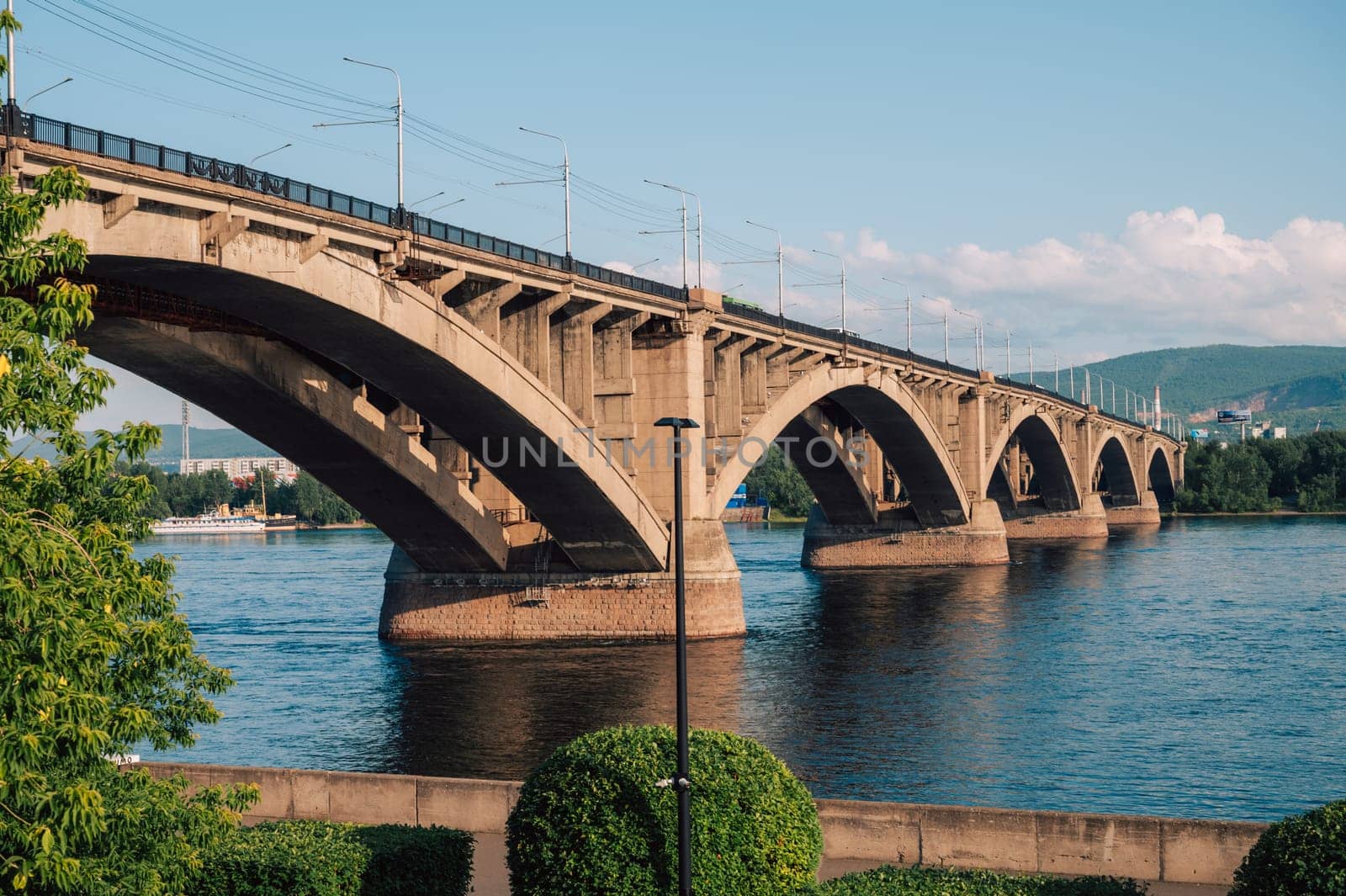 Communal bridge over the Yenisei River at beauty sunny summer day in Krasnoyarsk city.