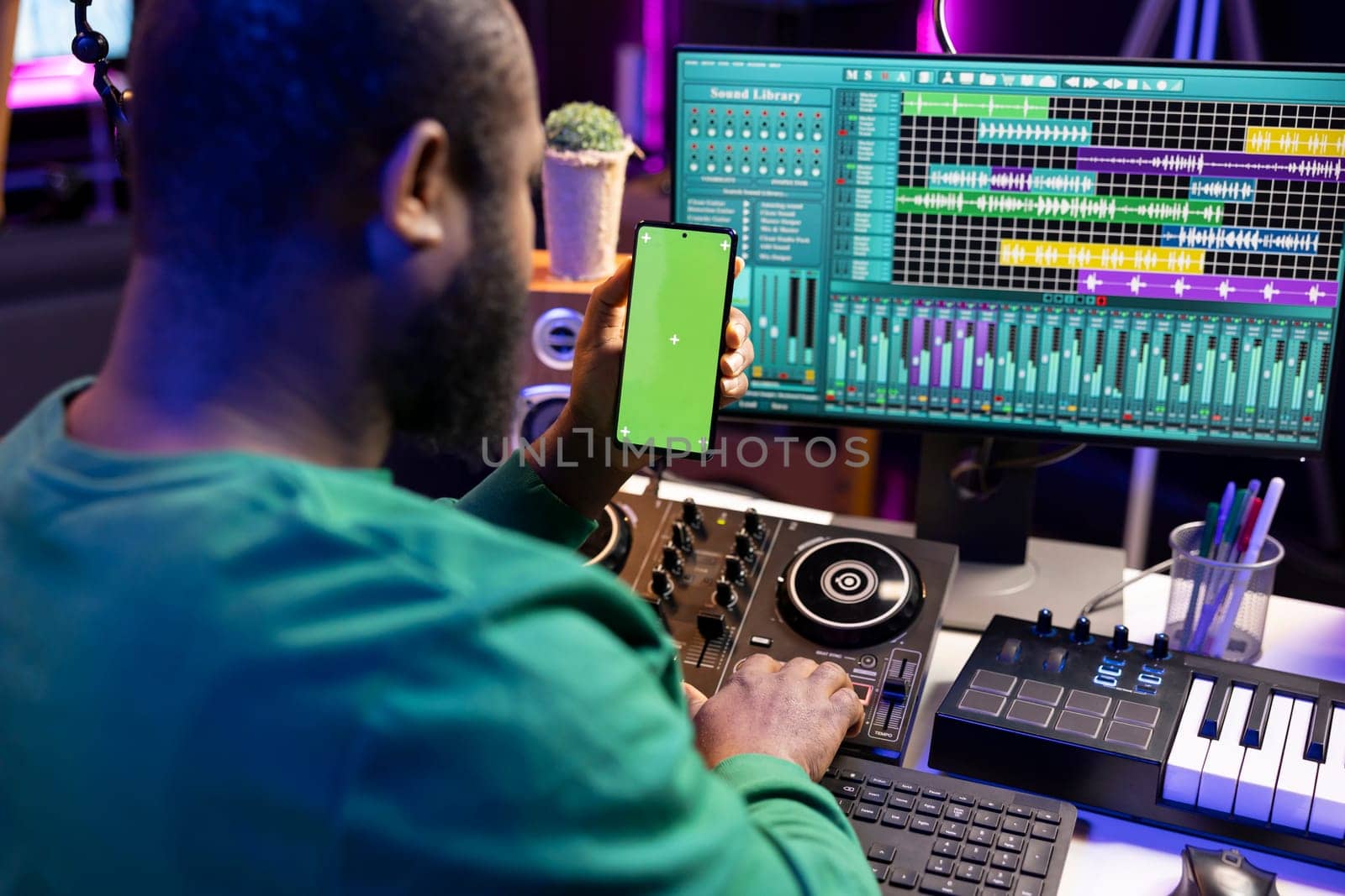 African american audio engineer recording and editing tracks with daw software by DCStudio