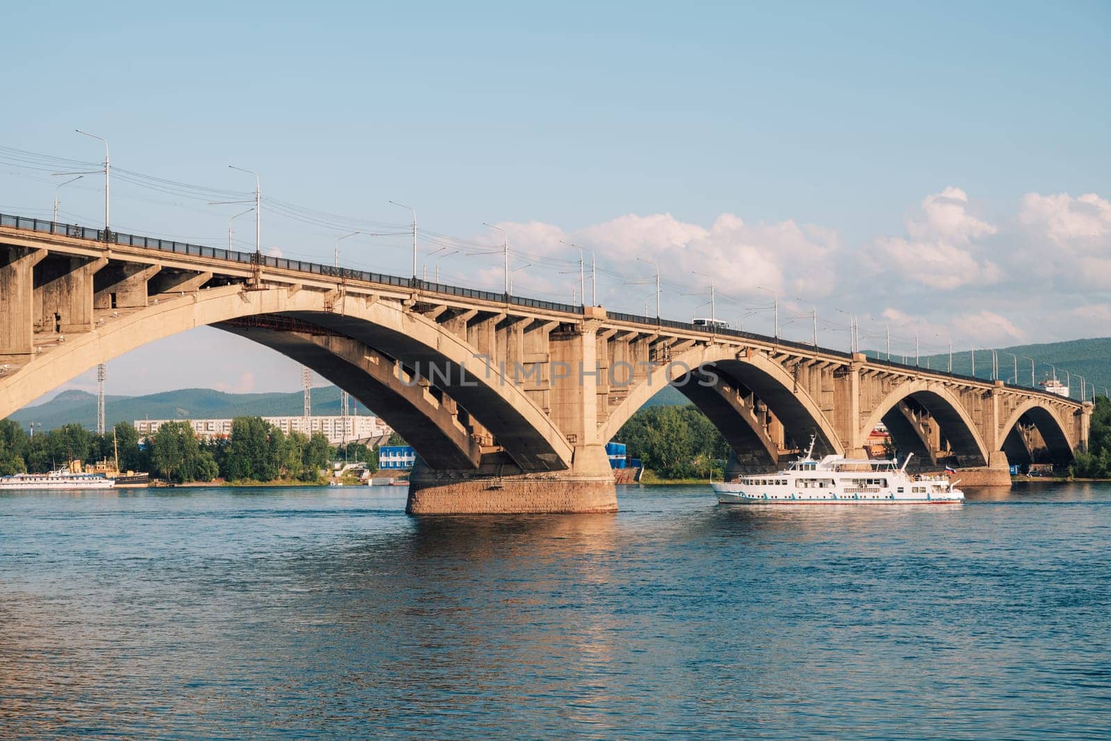 Communal bridge over the Yenisei River at beauty sunny summer day in Krasnoyarsk city.