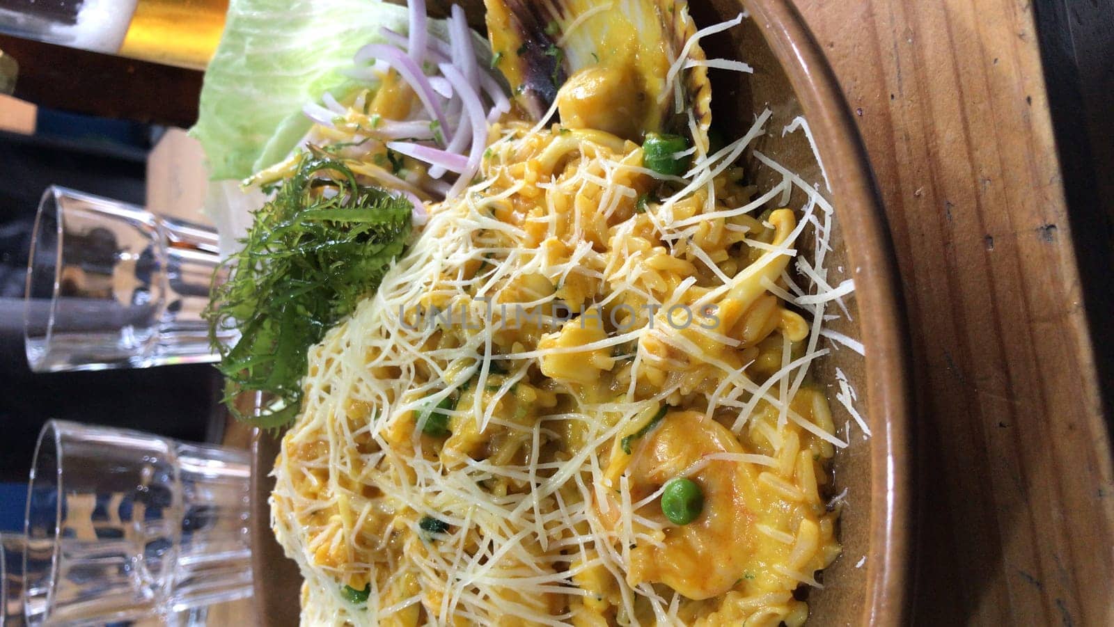 Authentic peruvian seafood cuisine with cheese sprinkled on top, accompanied by fresh herbs and onion