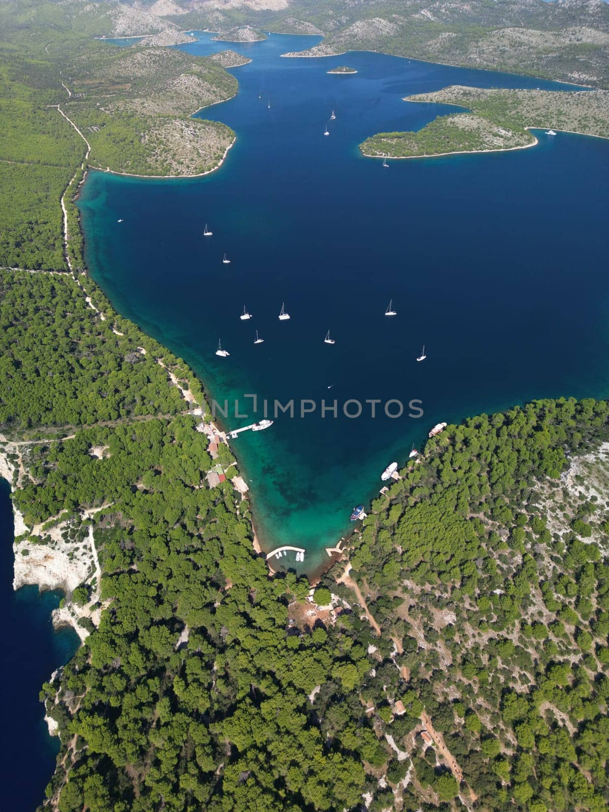 Drone view of yachts and boats in waters of Telascica bay in National Park, Croatia by Popov