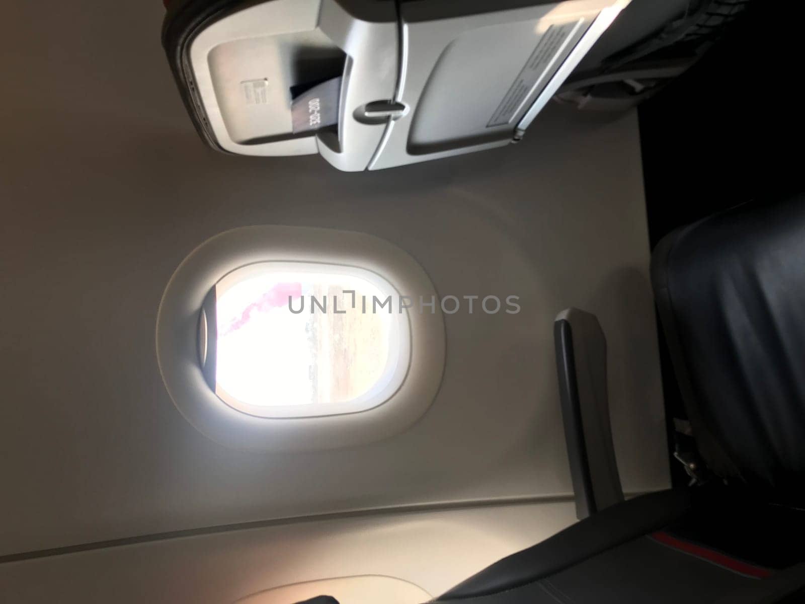 Soothing glimpse of sunlight through an airplane window, evoking the comfort of travel