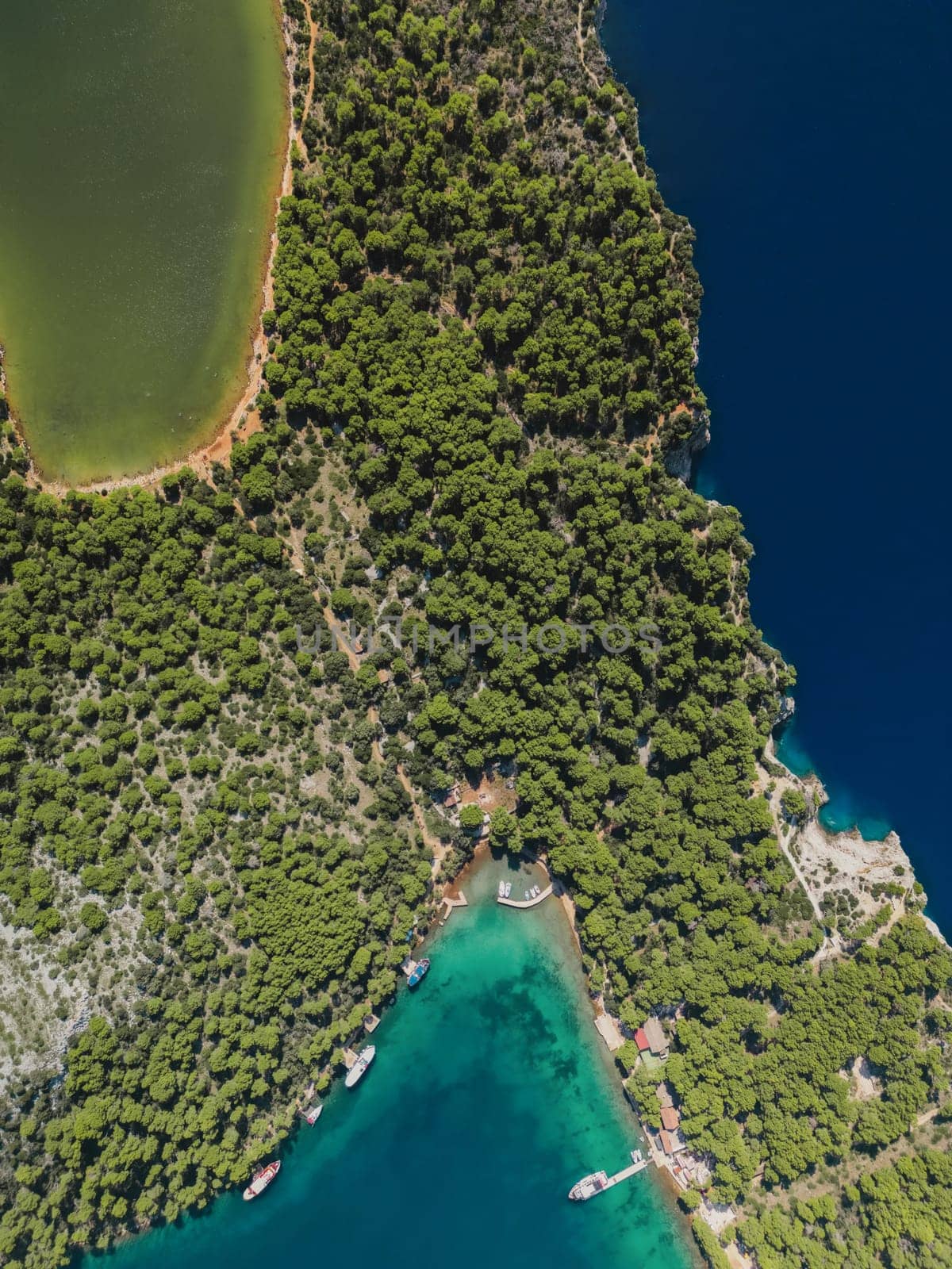 Drone above view of luxury yachts and small ships at pier on shore of Telascica bay in National Park, Croatia