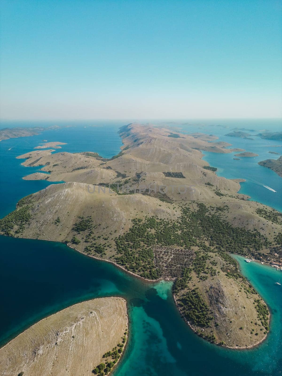 Drone aerial view of Kornati archipelago in Croatia, islands with coniferous trees growing on hillsides