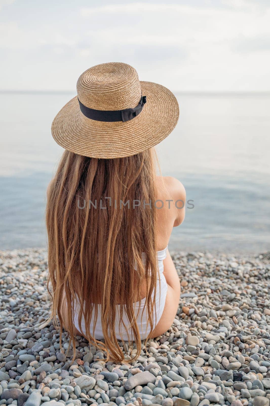 Freelance close up woman hands writing on computer. Well looking middle aged woman typing on laptop keyboard outdoors with beautiful sea view. by Matiunina