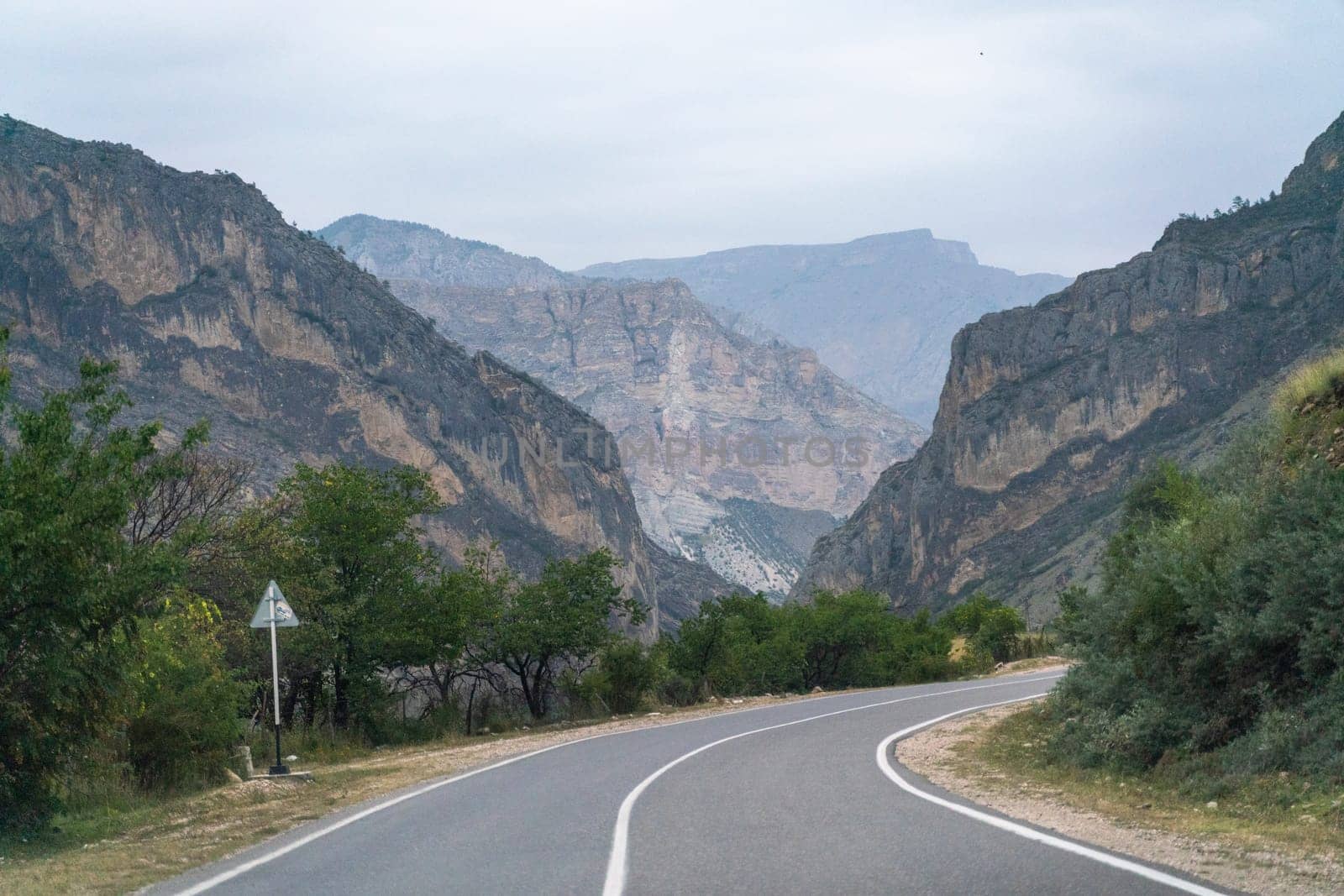 View from the car of an asphalt road in the mountainous area of Dagestan.