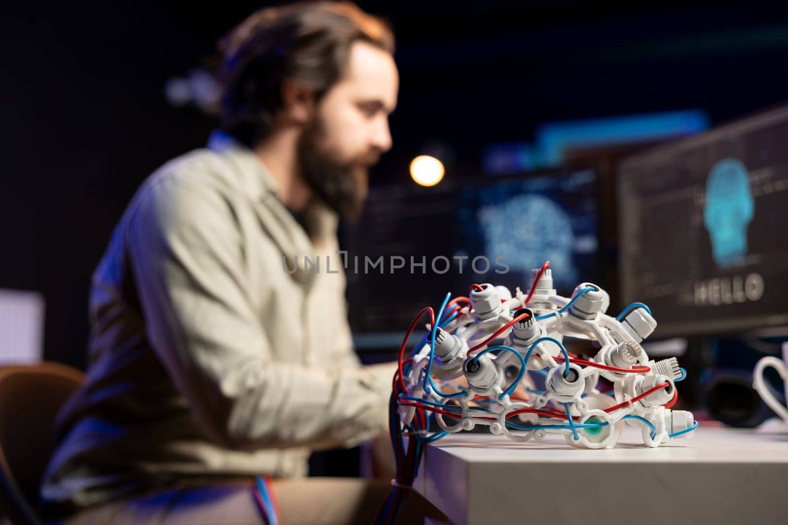 Focus on EEG headset used by engineer in blurry background to upload consciousness into computer. Close up shot of high tech gear used by IT expert to create connection between brain and PC