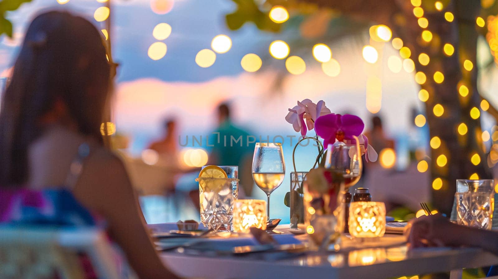 Coastal restaurant dinner, dining scene at sunset and a beautifully set table, softly blurred, romantic atmosphere with bokeh lights and a hint of the ocean, intimate celebration and a serene seaside view