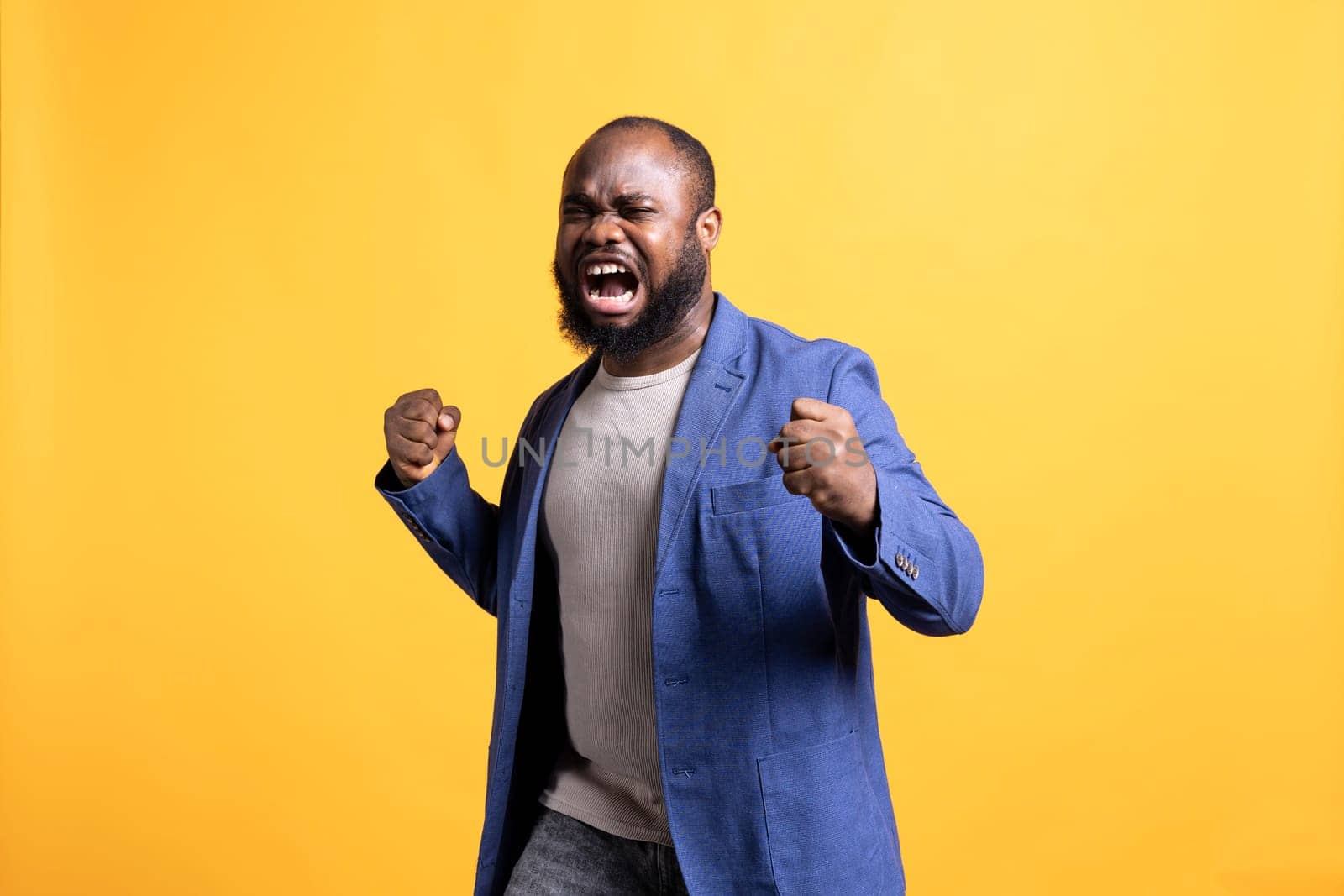 Upset man yelling in pain after hearing painful bad news, studio background by DCStudio