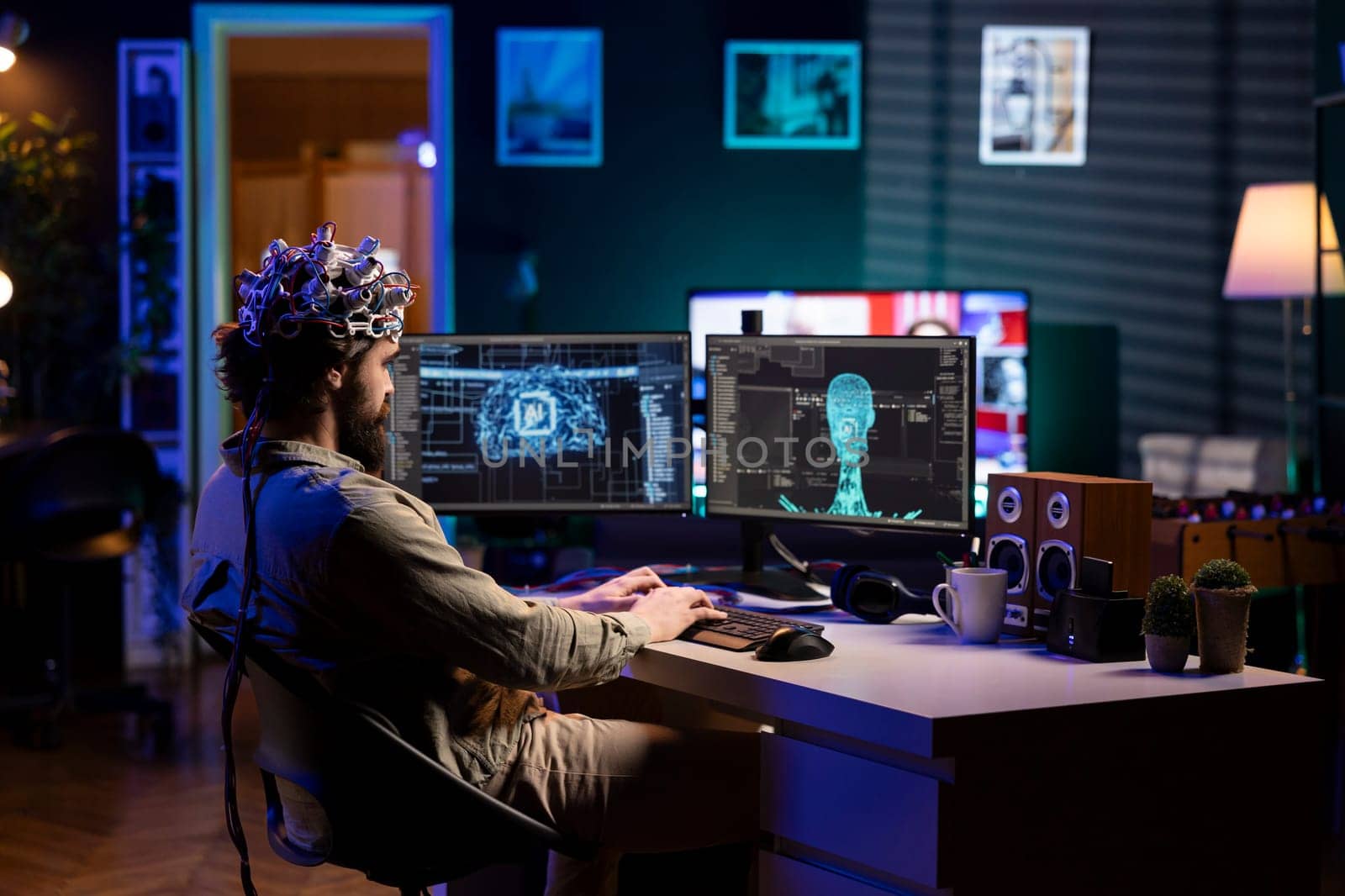 Computer scientist with EEG headset on programming brain transfer into computer virtual world, merging with artificial intelligence. IT specialist at home using neuroscience to gain digital soul