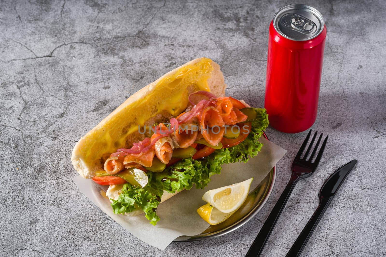 Smoked salmon sandwich on metal plate on stone table by Sonat