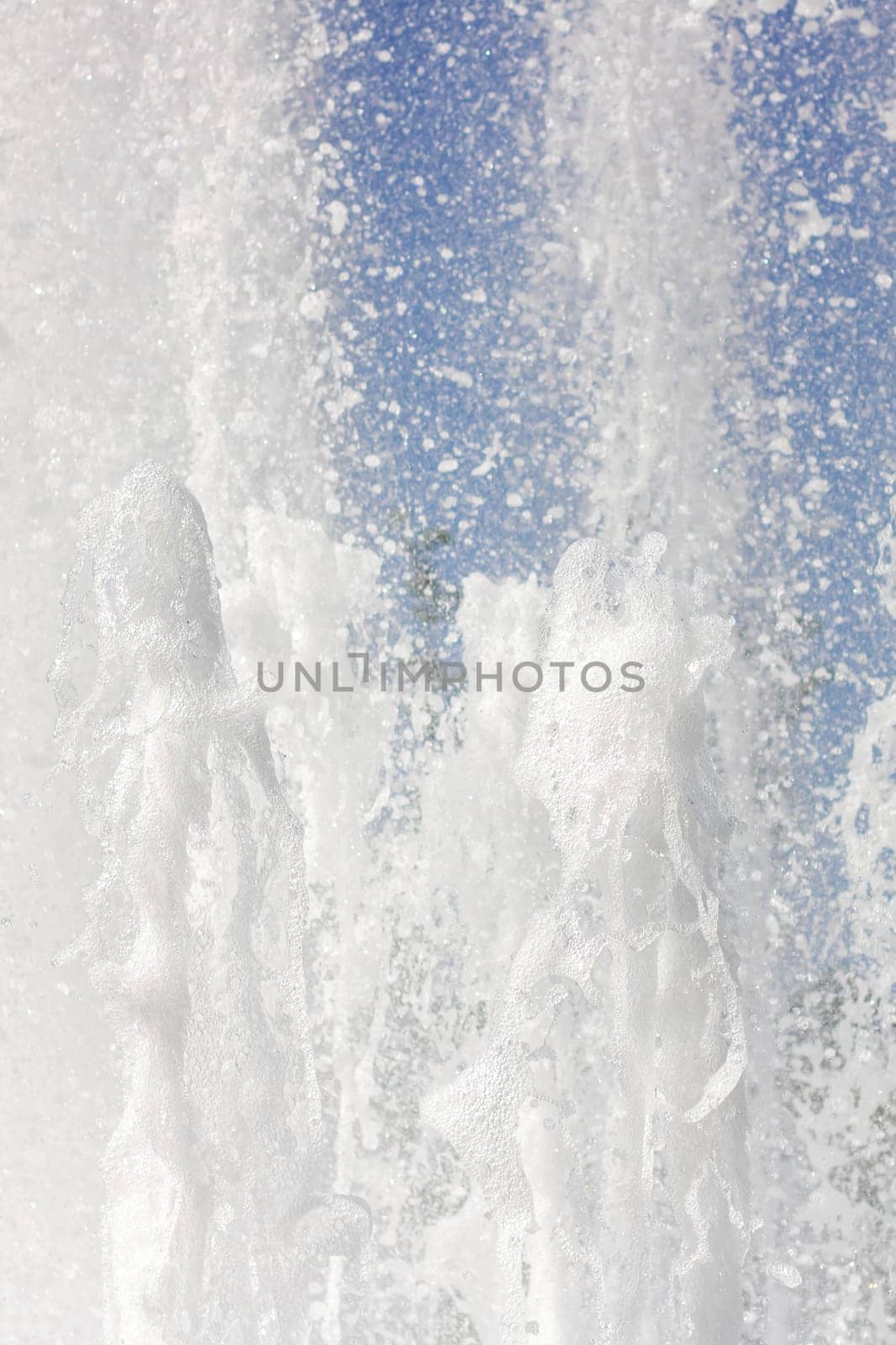 Water fountain splashing liquid against an electric blue sky by Vera1703