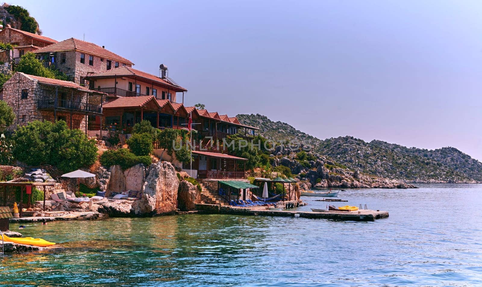 Uncover a serene cove with charming stone cottages, a floating dock, and breathtaking views. Dive into the clear waters, bask in the sun, and embrace the tranquility of this hidden gem by the sea.