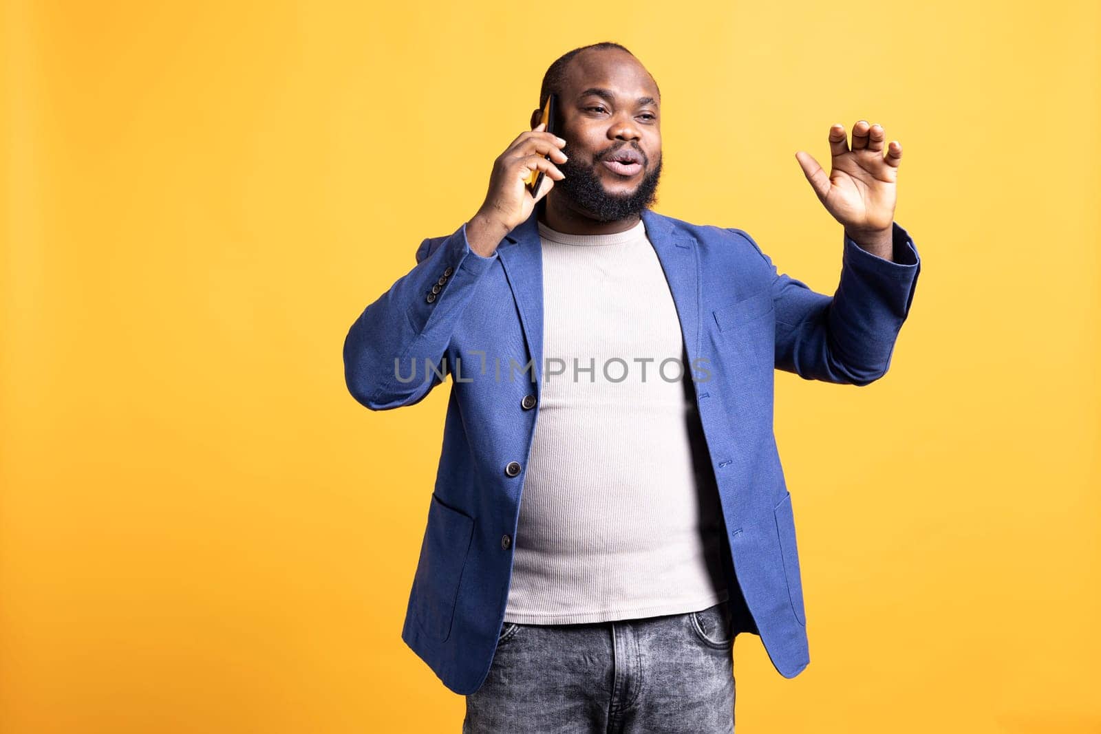 Happy person receiving good news during phone call, studio background by DCStudio