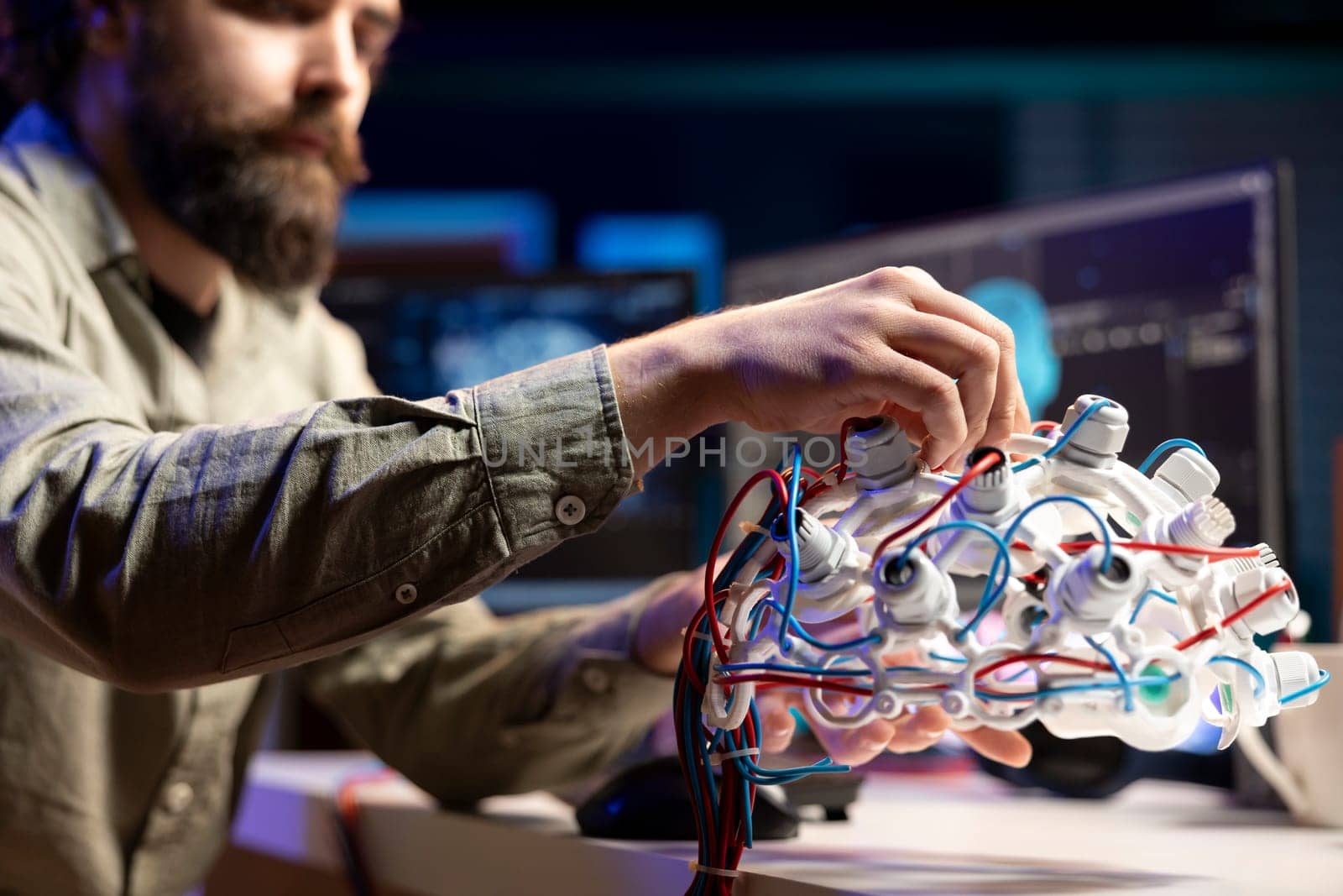 Computer scientist installing electrodes wires on EEG headset by DCStudio