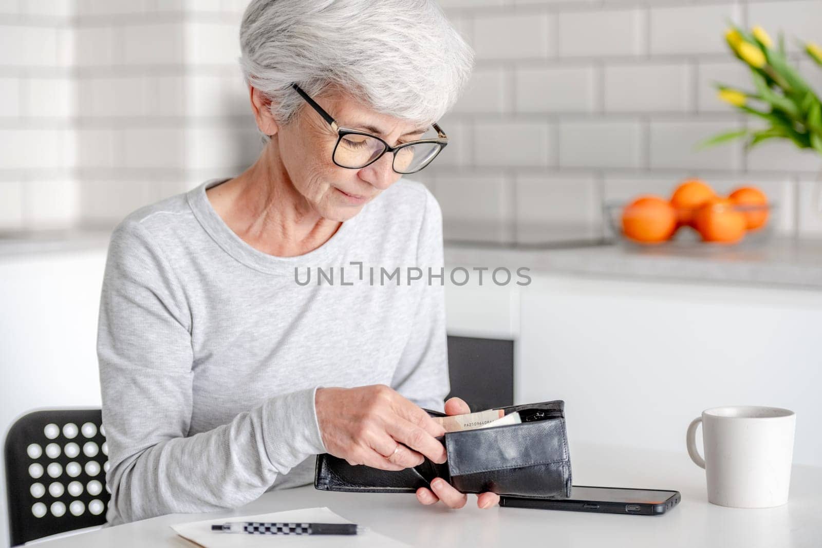 Smiling Elderly Woman Counts Euro Money In Wallet