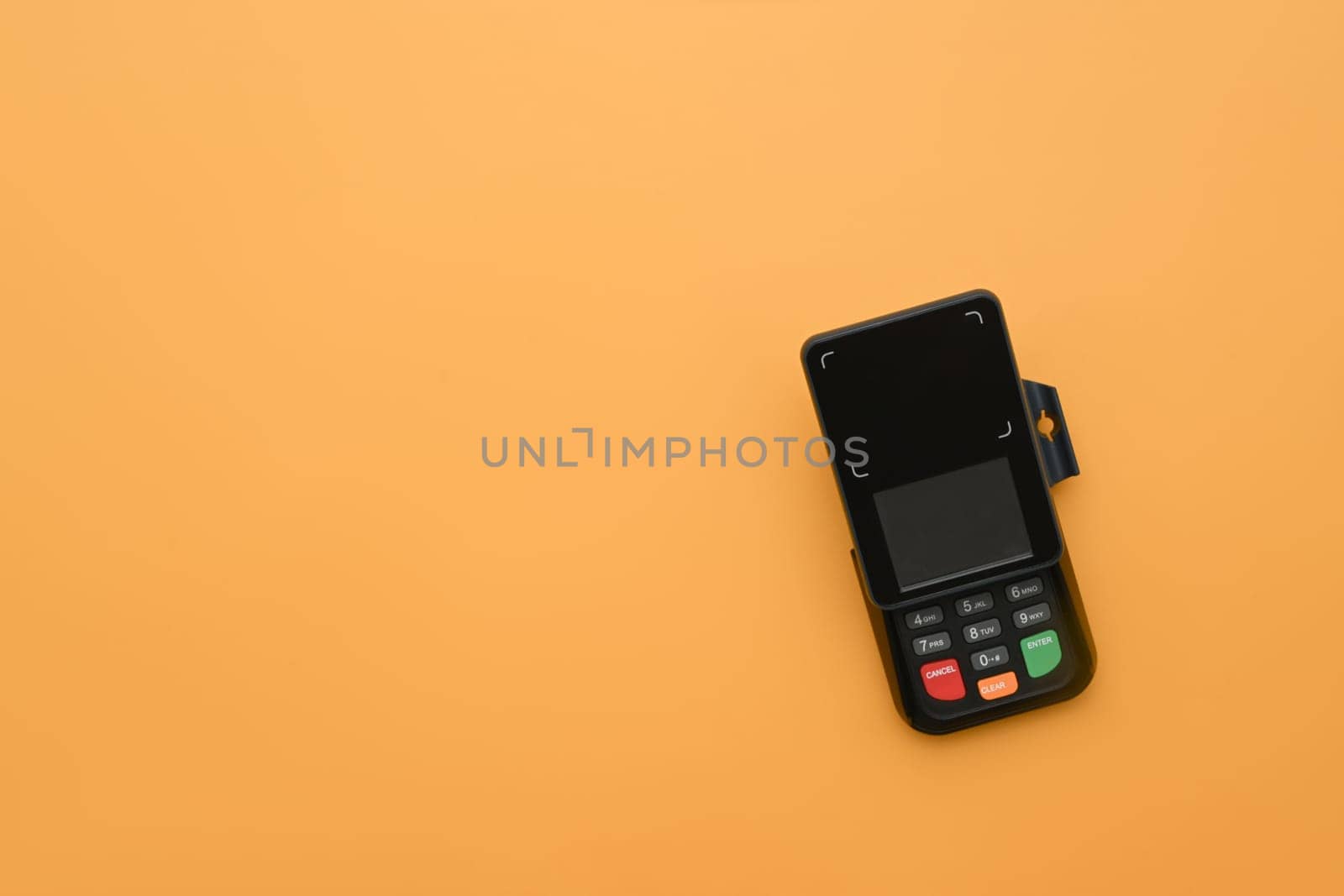 Modern payment terminal on yellow background. Modern payment systems concept.